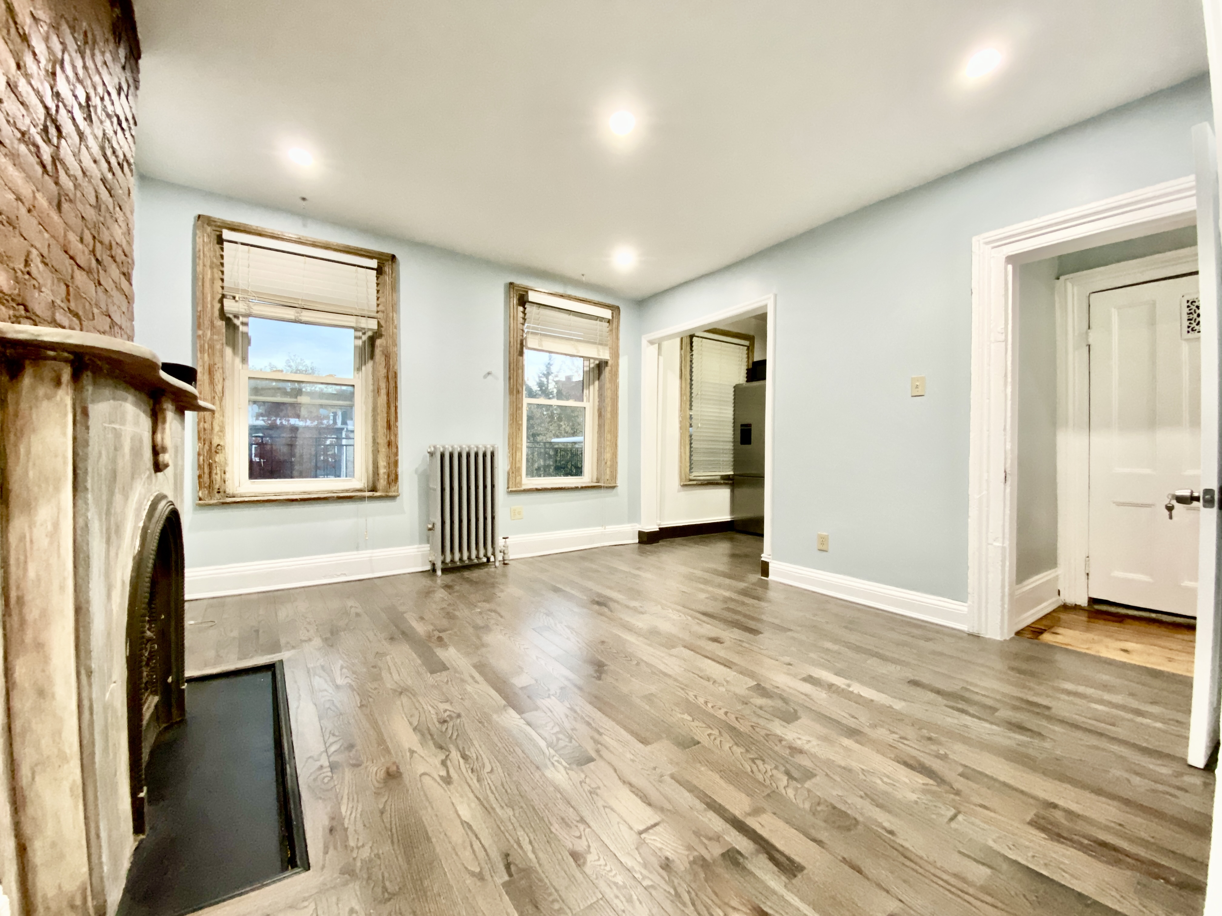 wooden floor in an empty room with a fireplace