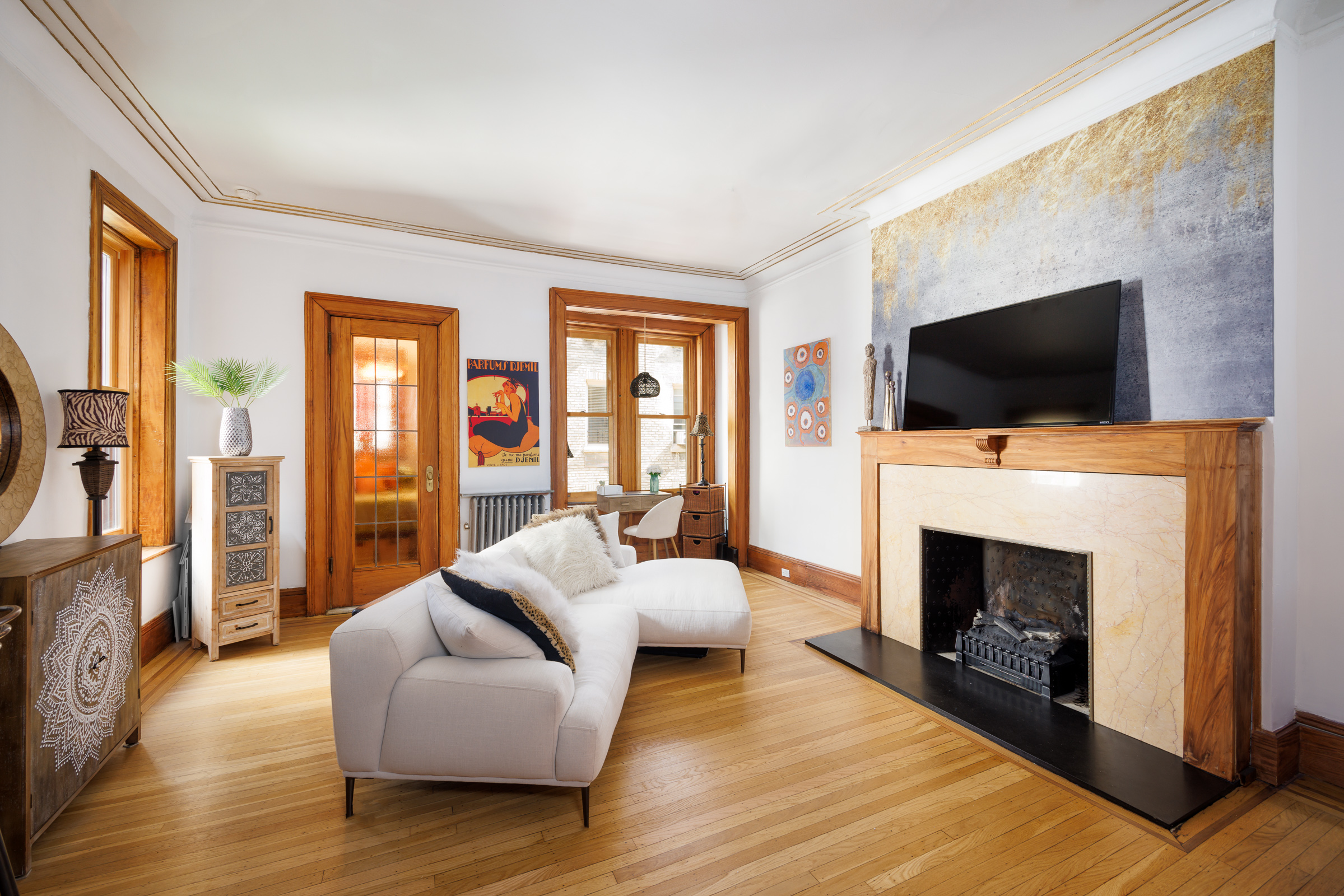 a living room with furniture a fireplace and a flat screen tv