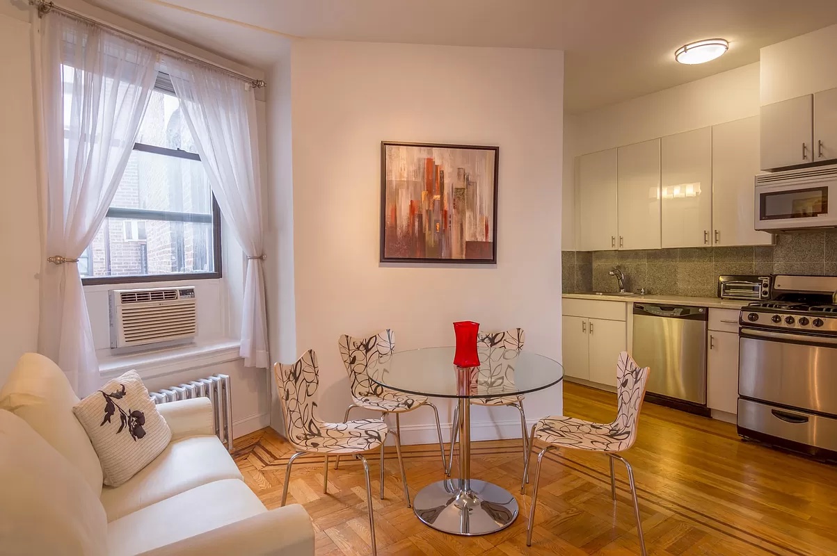 a living room with furniture and kitchen view