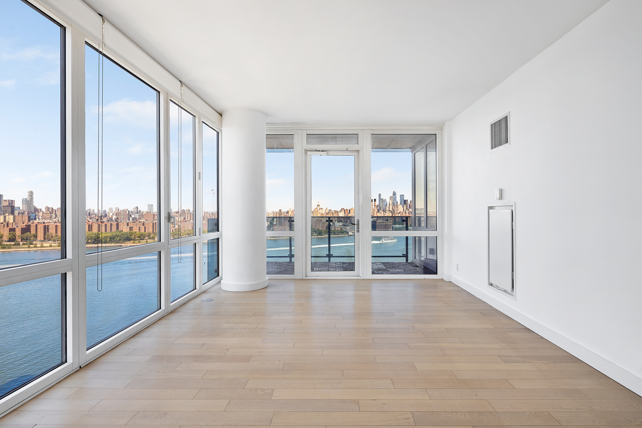 a view of a big room with windows and front door