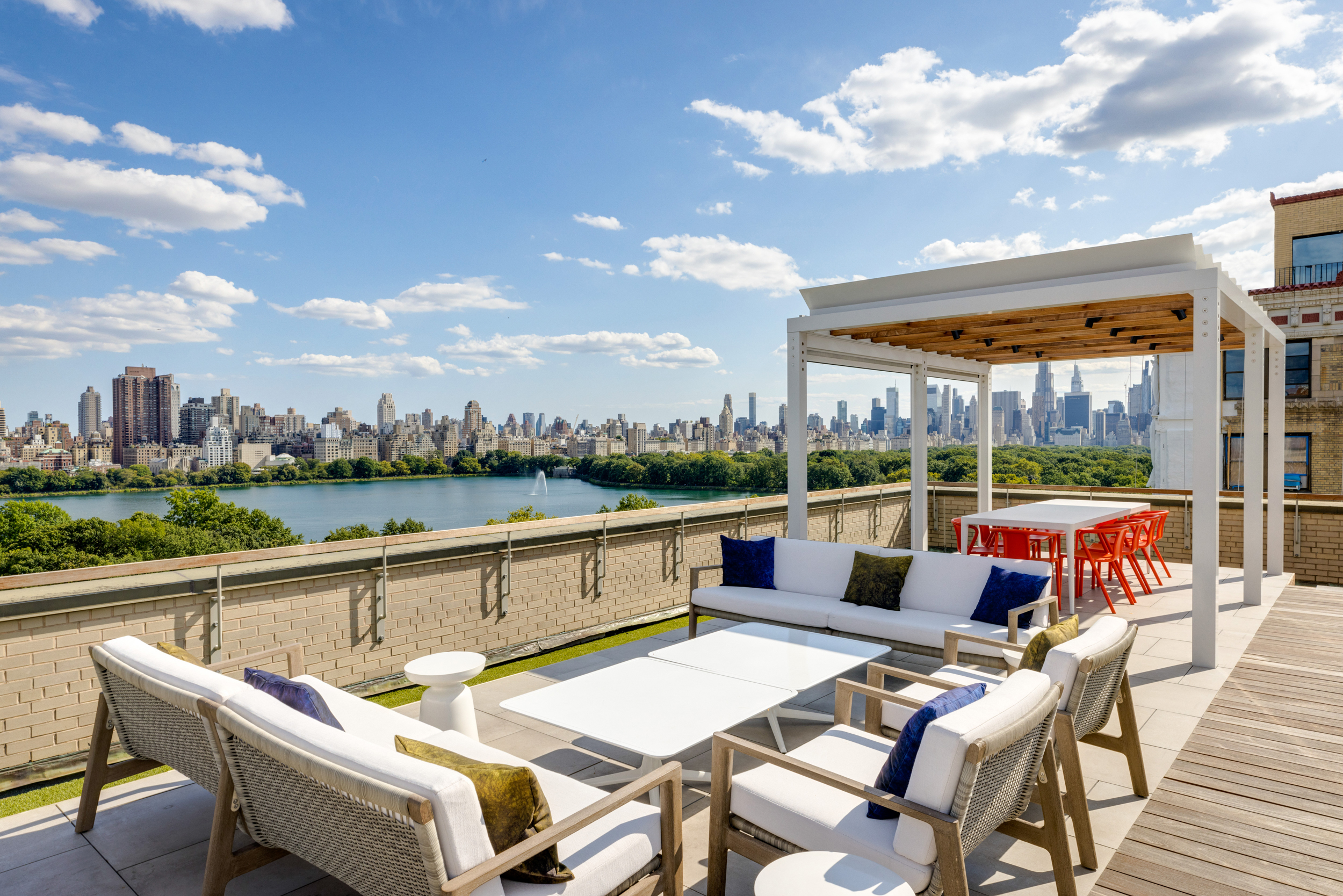 a view of swimming pool with outdoor seating and city view