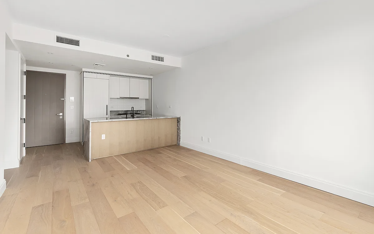 a view of a kitchen with a sink and a refrigerator