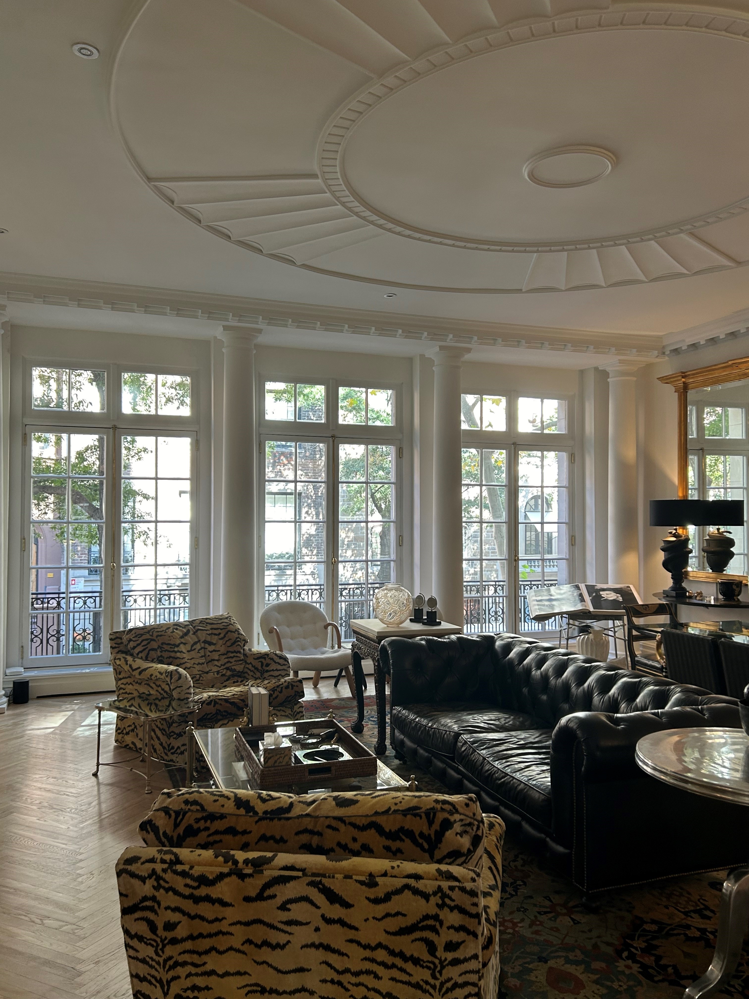 a living room with furniture and large windows