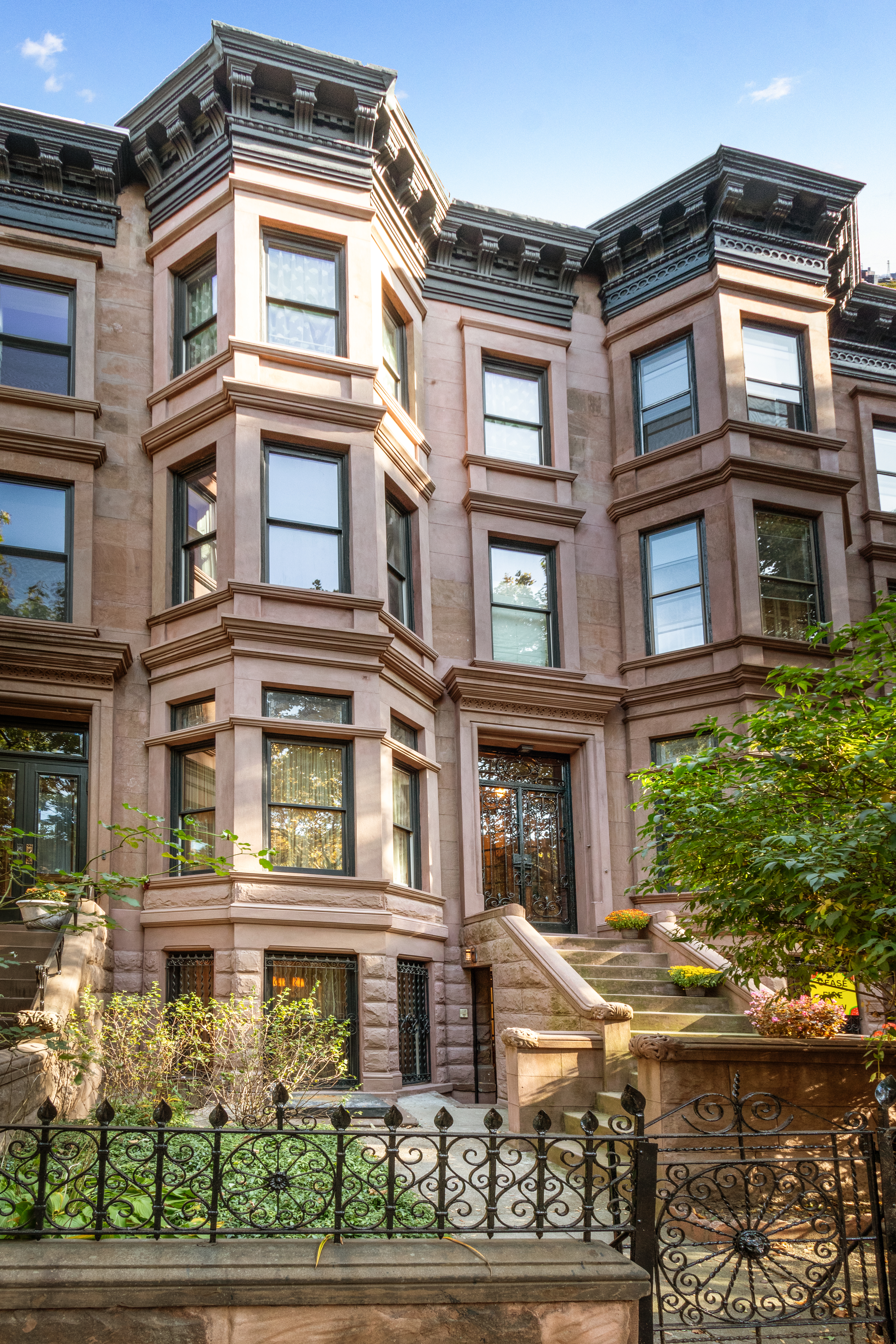 a front view of a residential apartment building with a yard