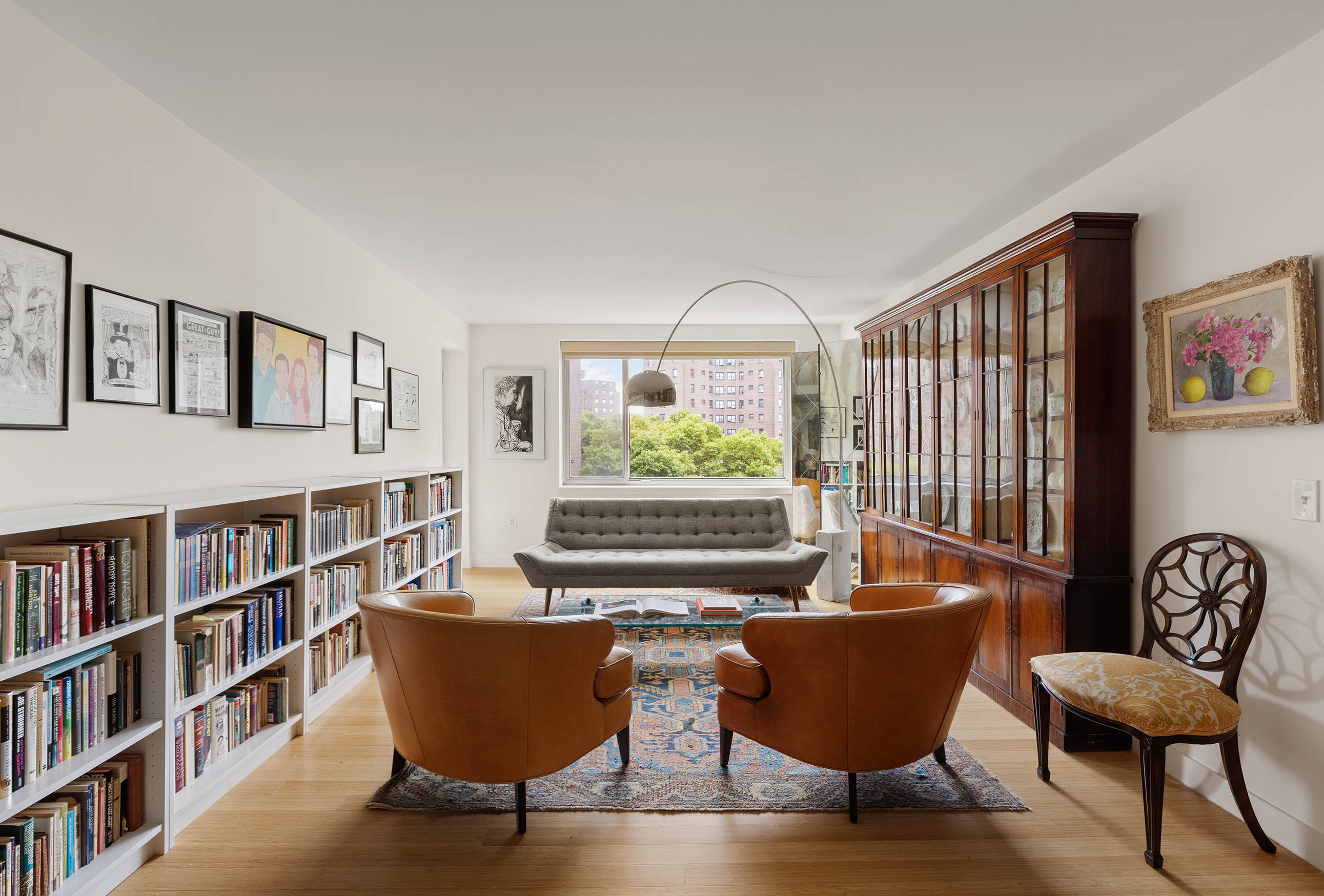 a living room with furniture and a book shelf