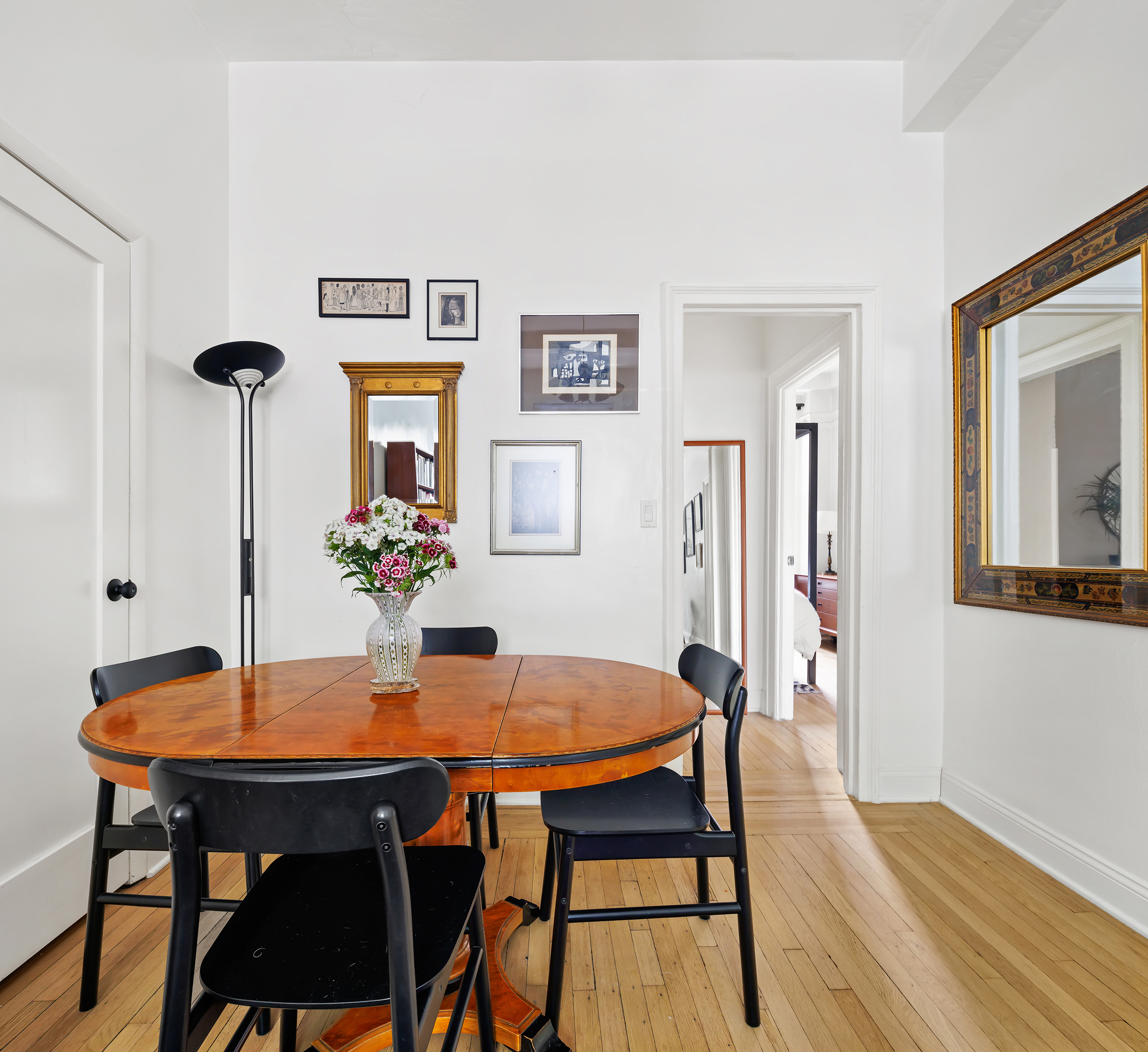 a view of a dining room with furniture and wooden floor