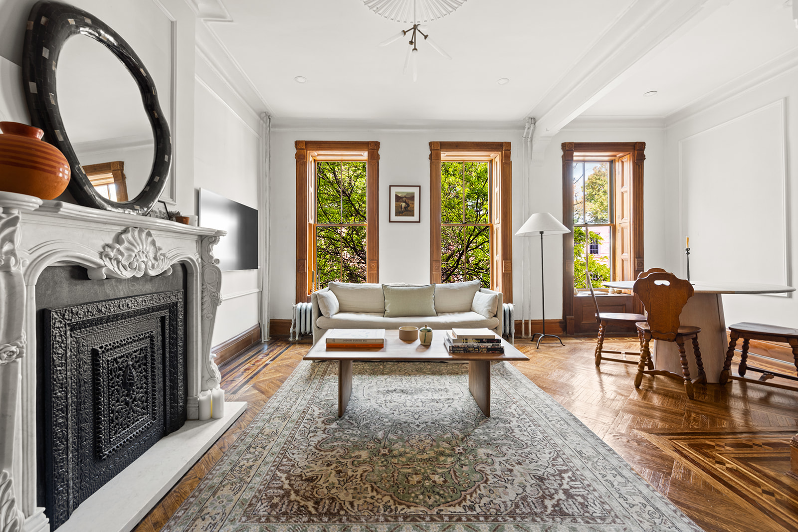 a living room with furniture a fireplace and a floor to ceiling window