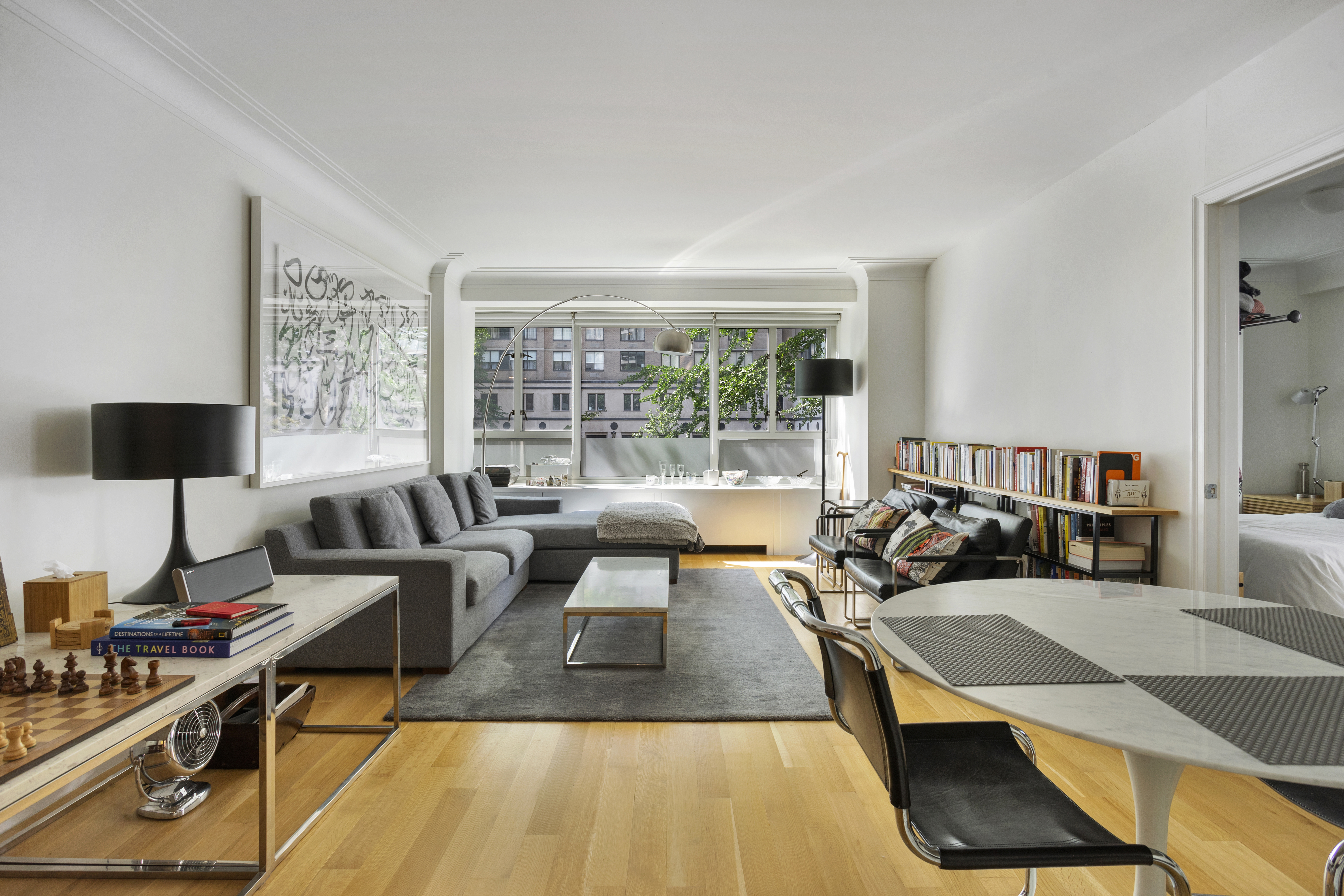 a living room with furniture a flat screen tv and a large window