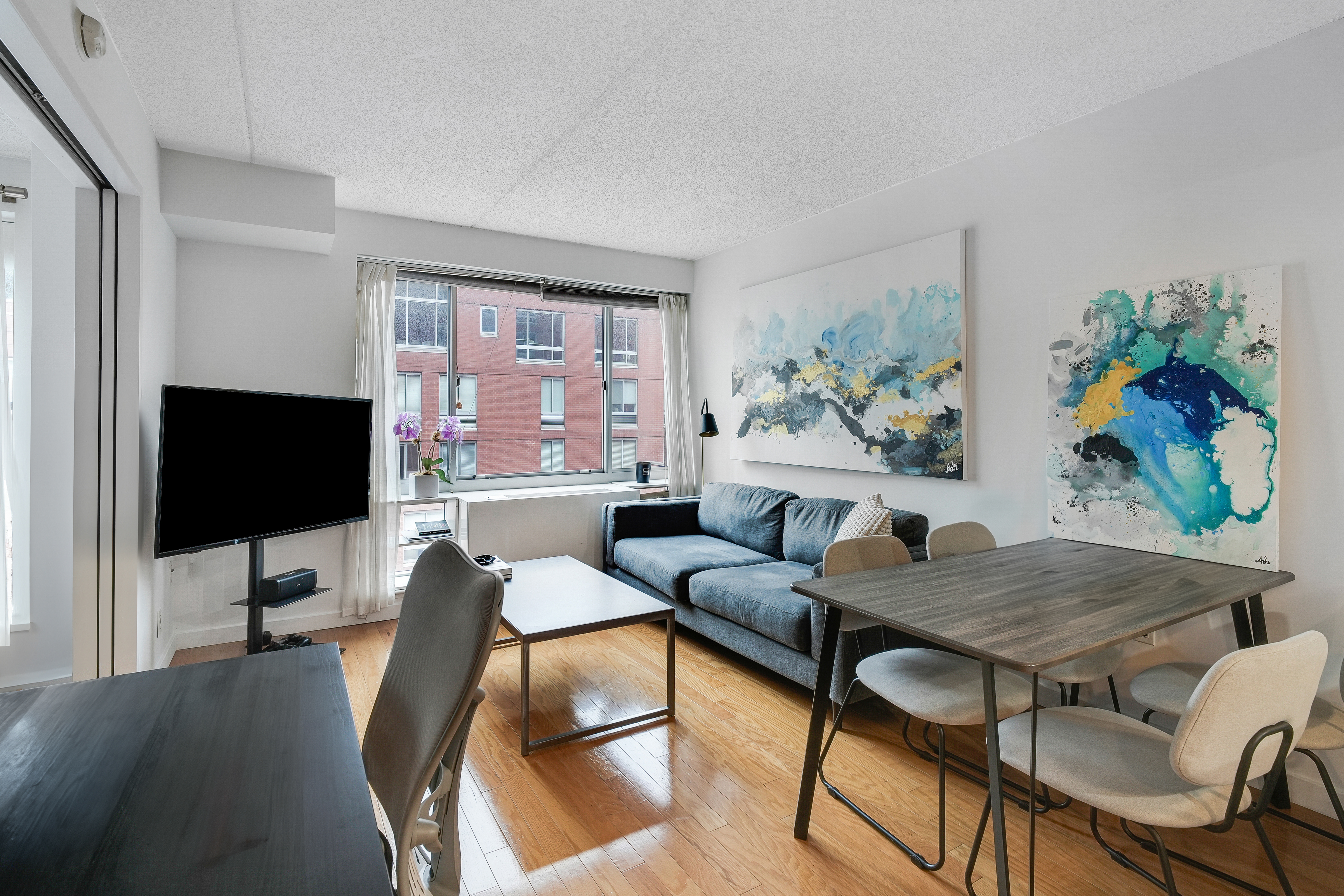 a living room with furniture and a flat screen tv