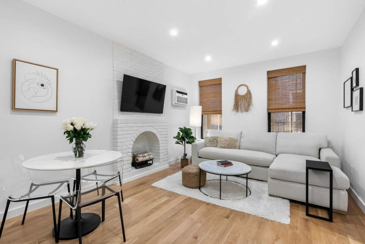 a living room with furniture a fireplace and a flat screen tv