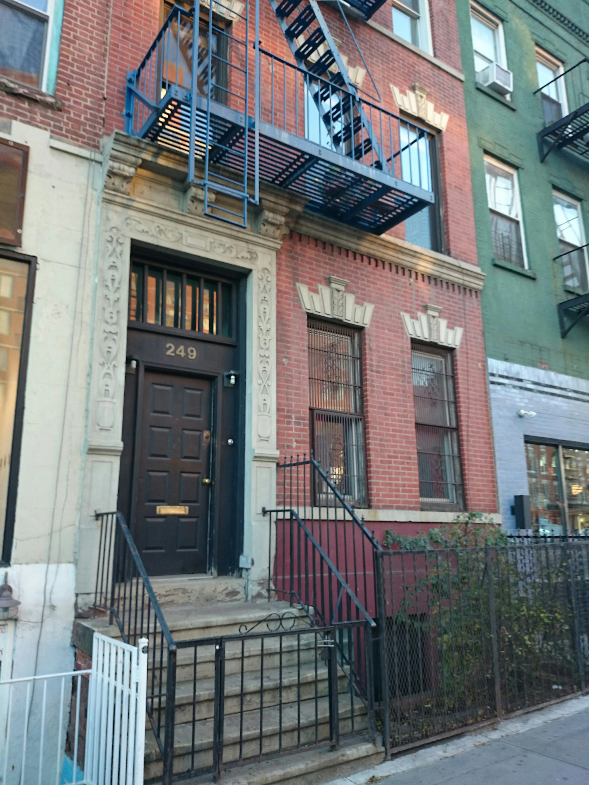 front view of a brick house with a small yard