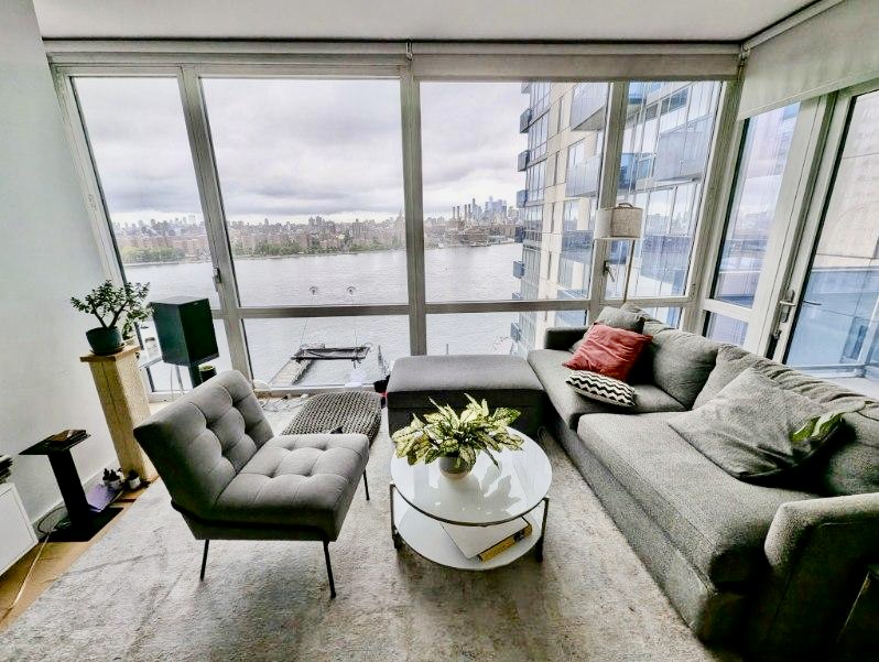 a living room with furniture and a large window