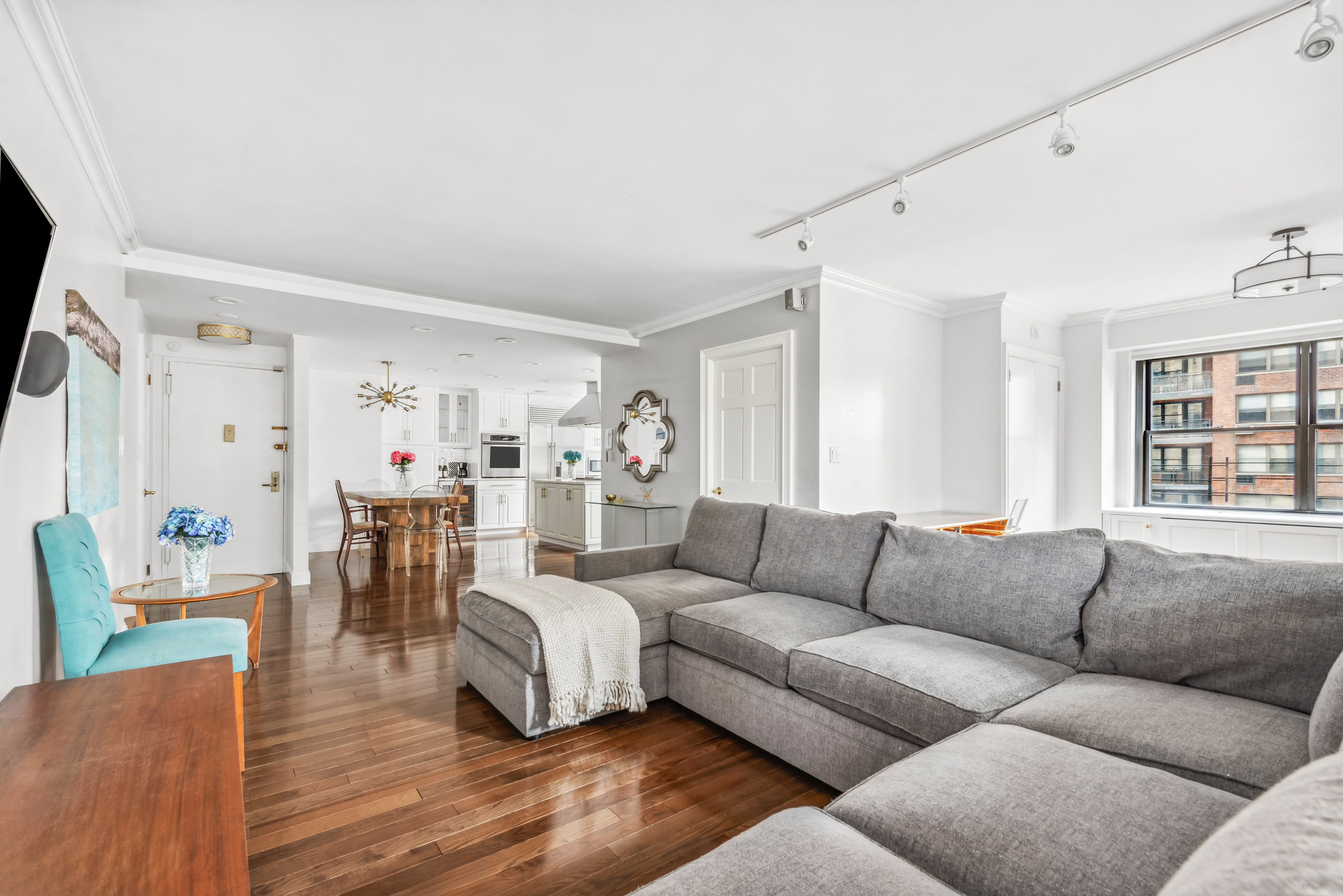 a living room with furniture and wooden floor