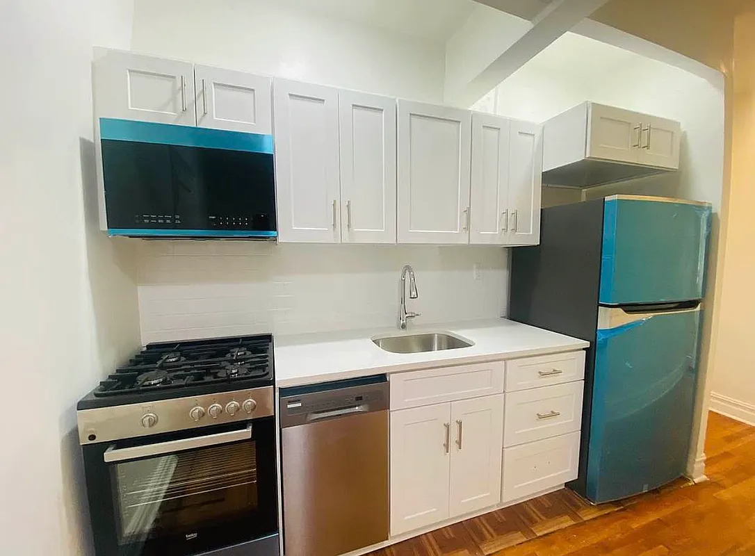 a kitchen with a sink and a stove top oven