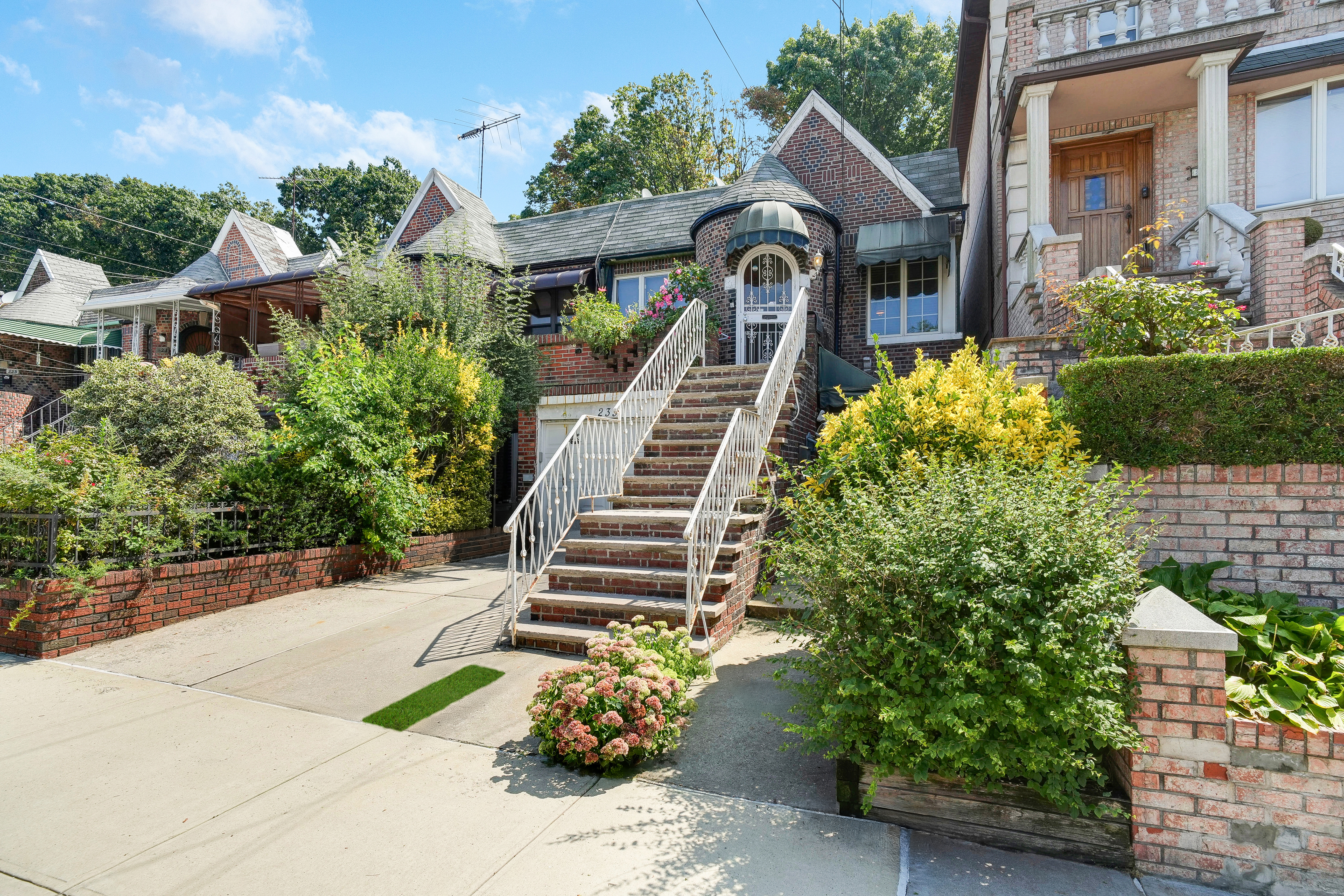 a front view of a house with a garden