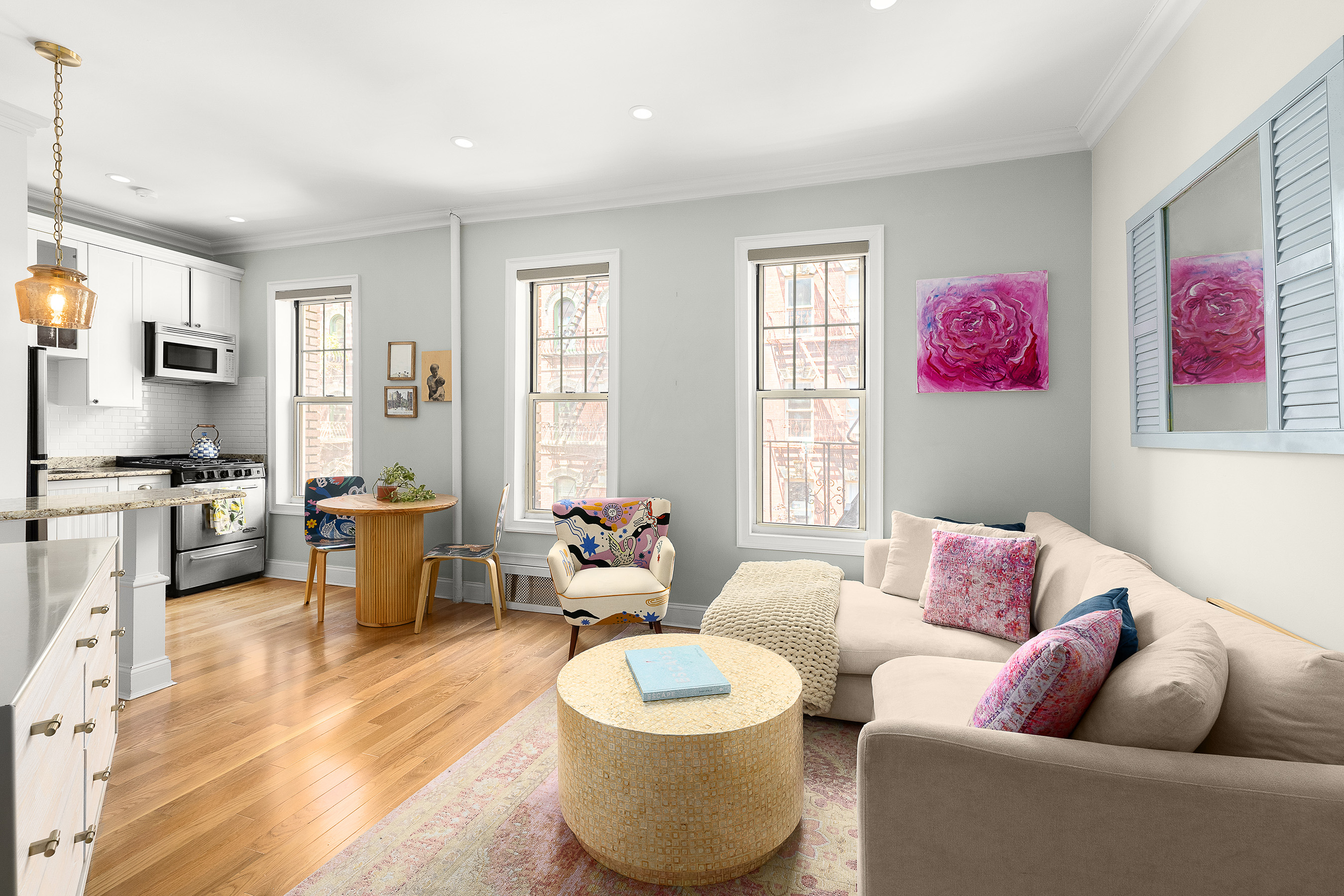 a living room with furniture and a wooden floor