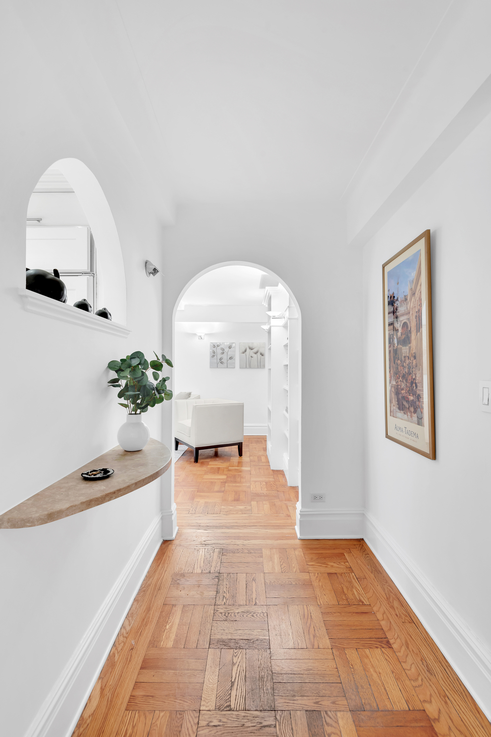 a living room with furniture and a potted plant