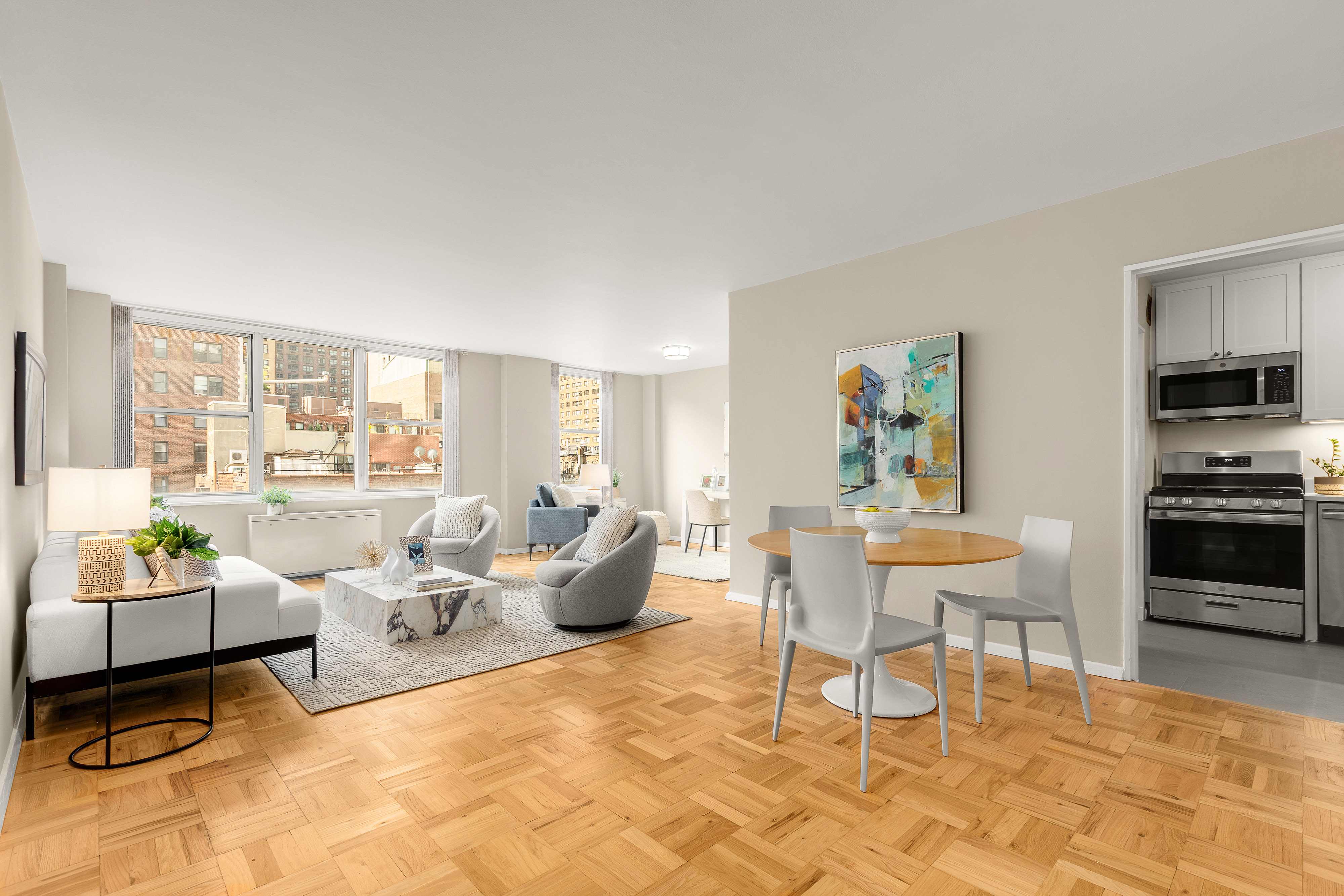 a living room with furniture and a dining table with rug