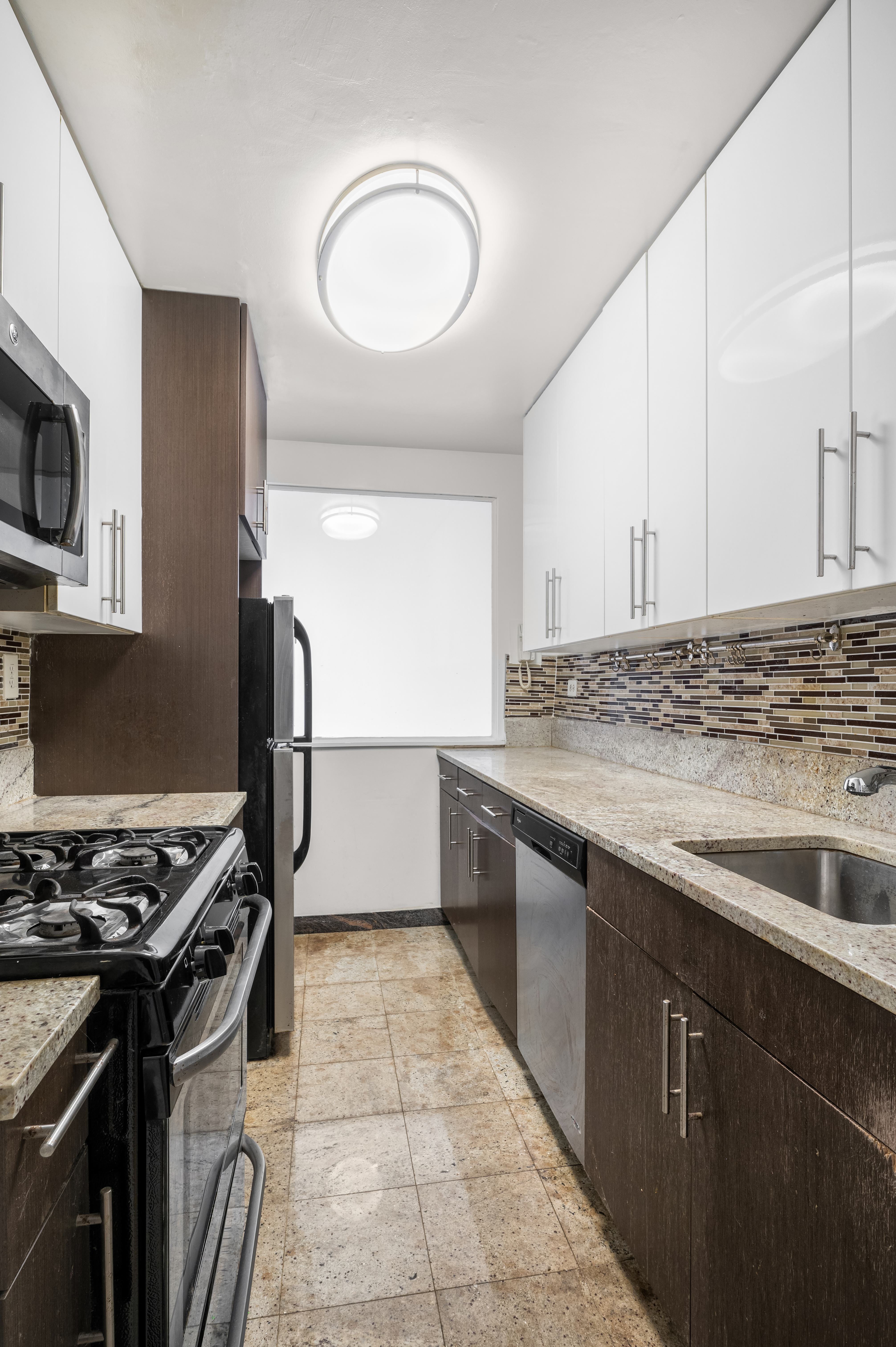 a kitchen with stainless steel appliances granite countertop a stove and a sink