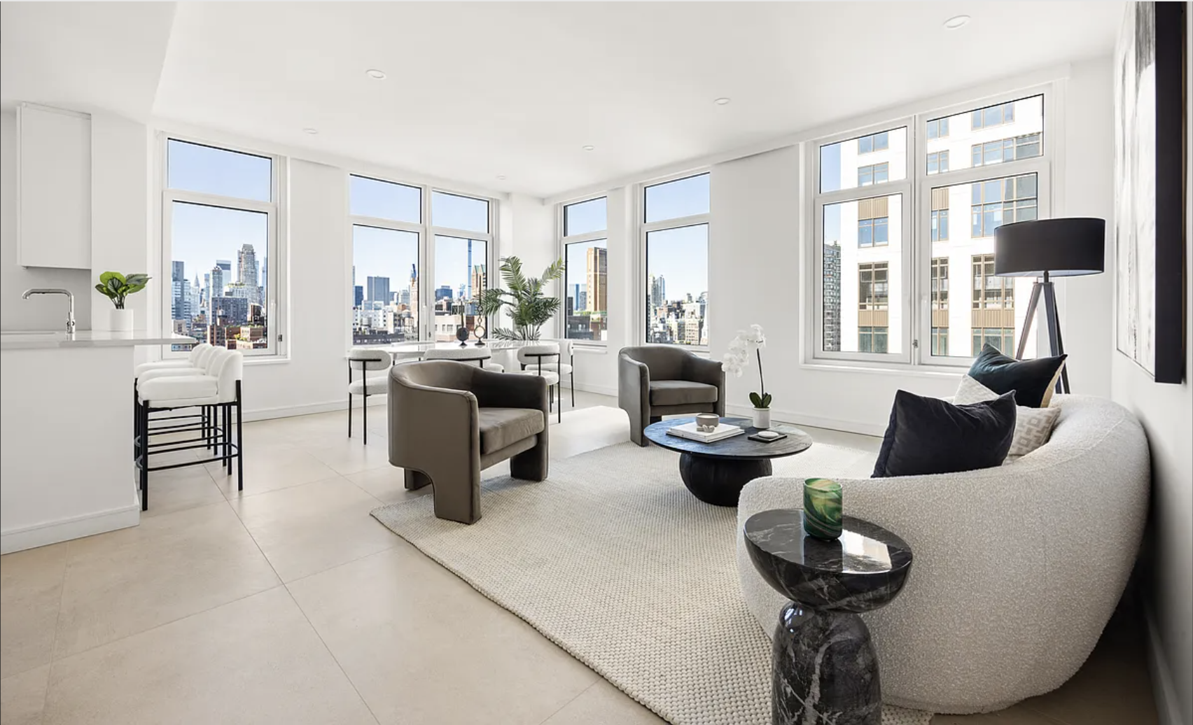 a living room with furniture and floor to ceiling windows