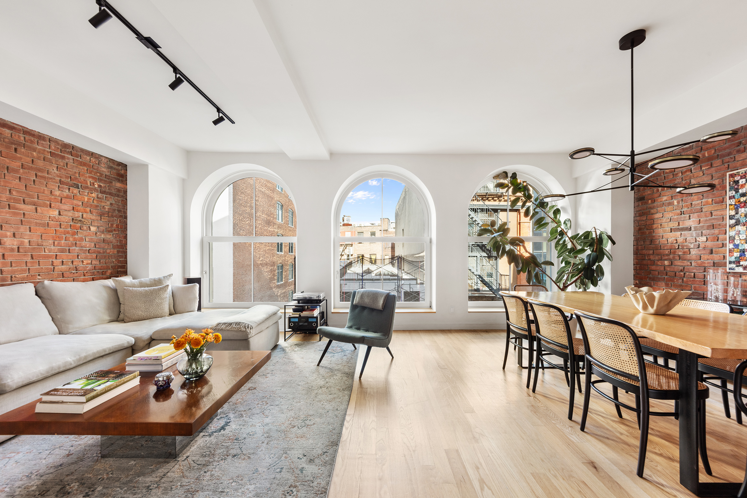 a living room with furniture and wooden floor