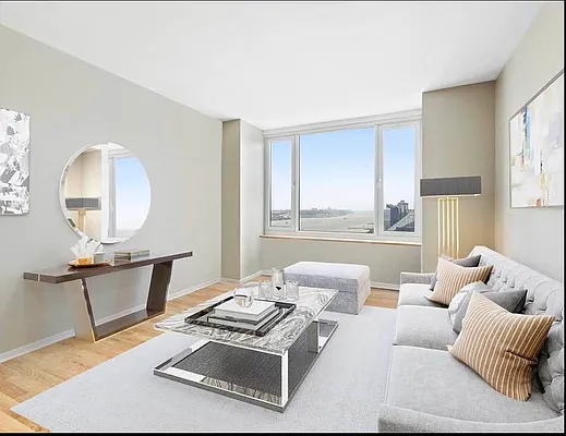 a living room with furniture a rug and a window