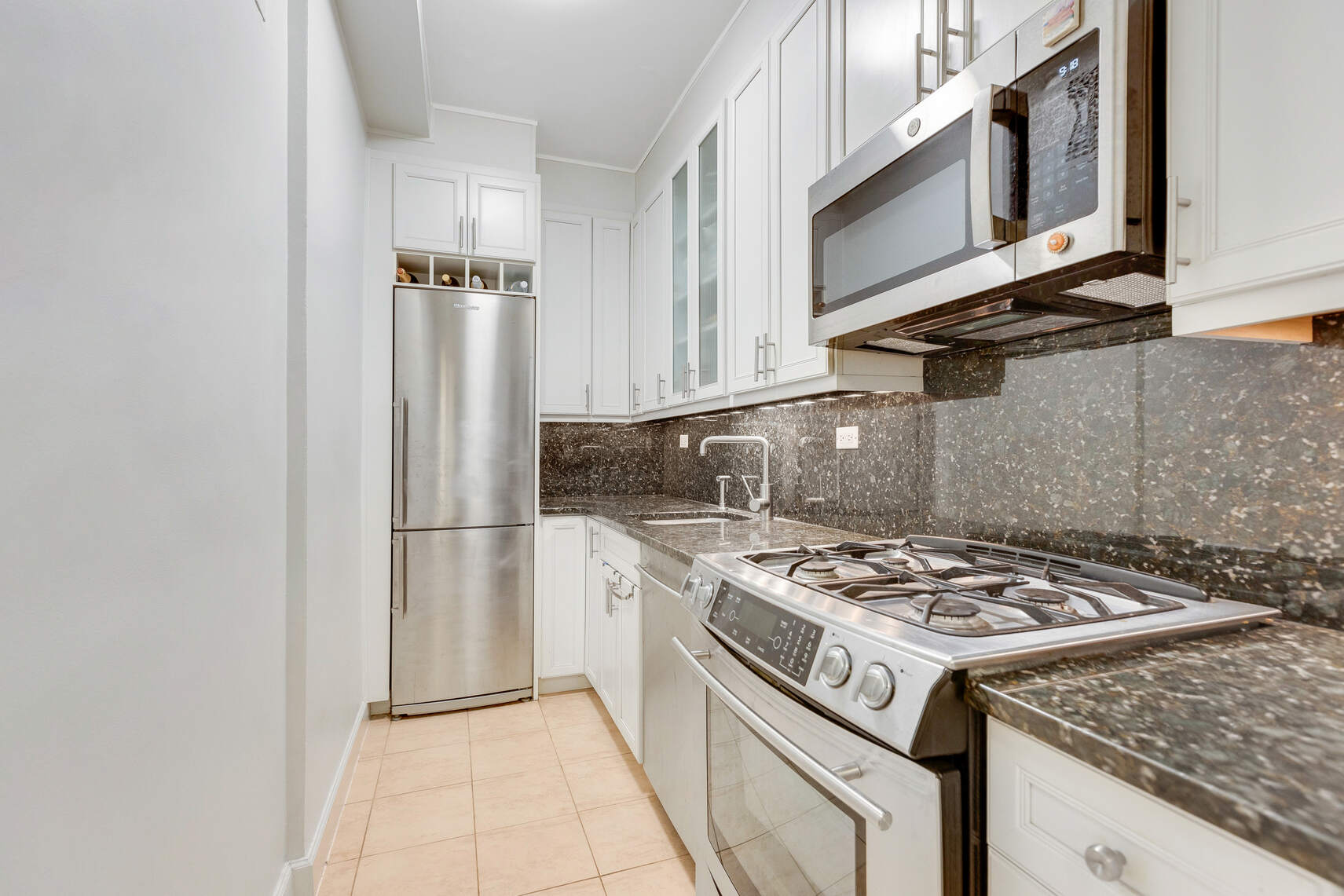 a kitchen with a stove and a refrigerator