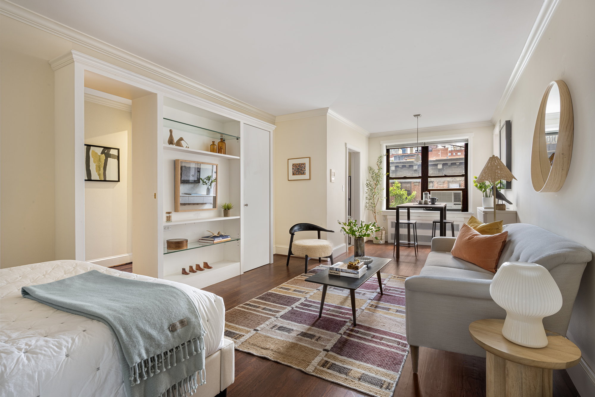 a bedroom with a bed and wooden floor