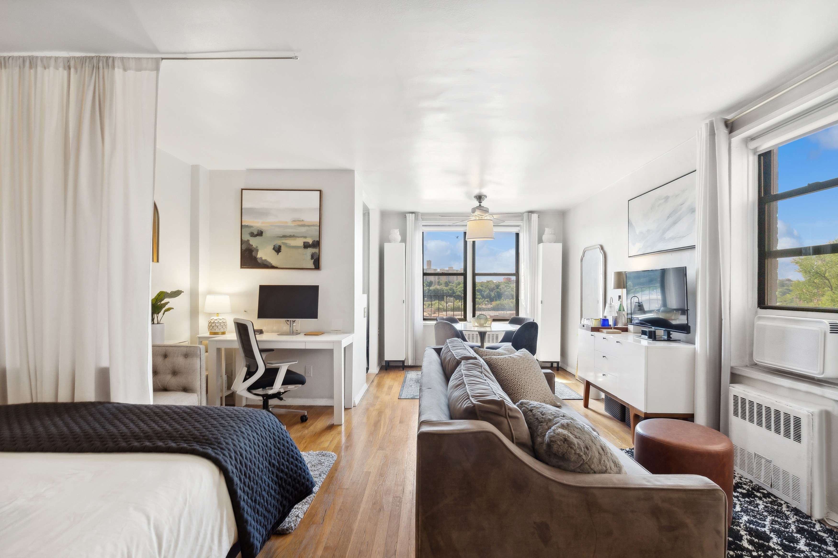 a bedroom with furniture and a large window