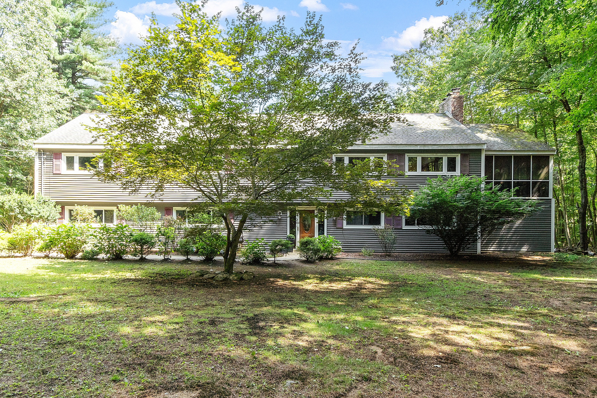 a view of a house with garden and sitting area