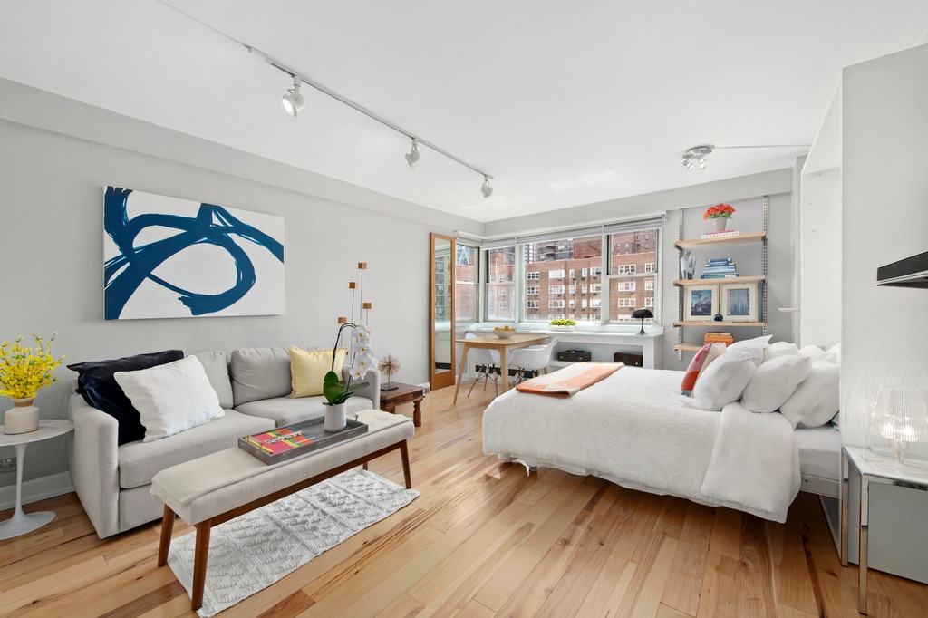 a bedroom with furniture and wooden floor