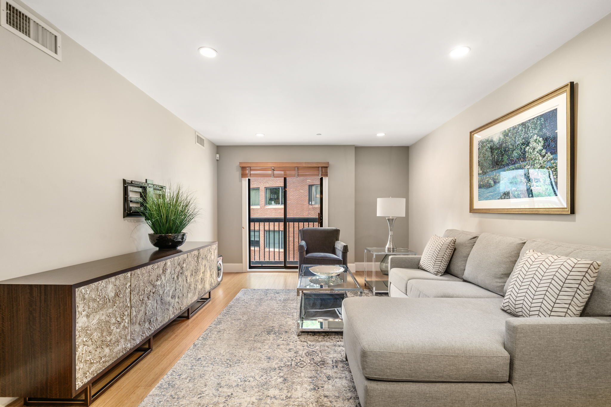 a living room with furniture and wooden floor