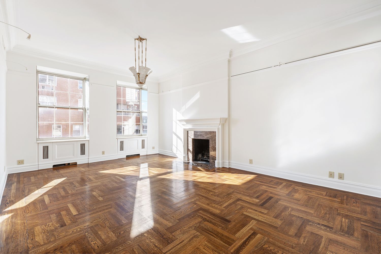 a view of empty room with fireplace and windows