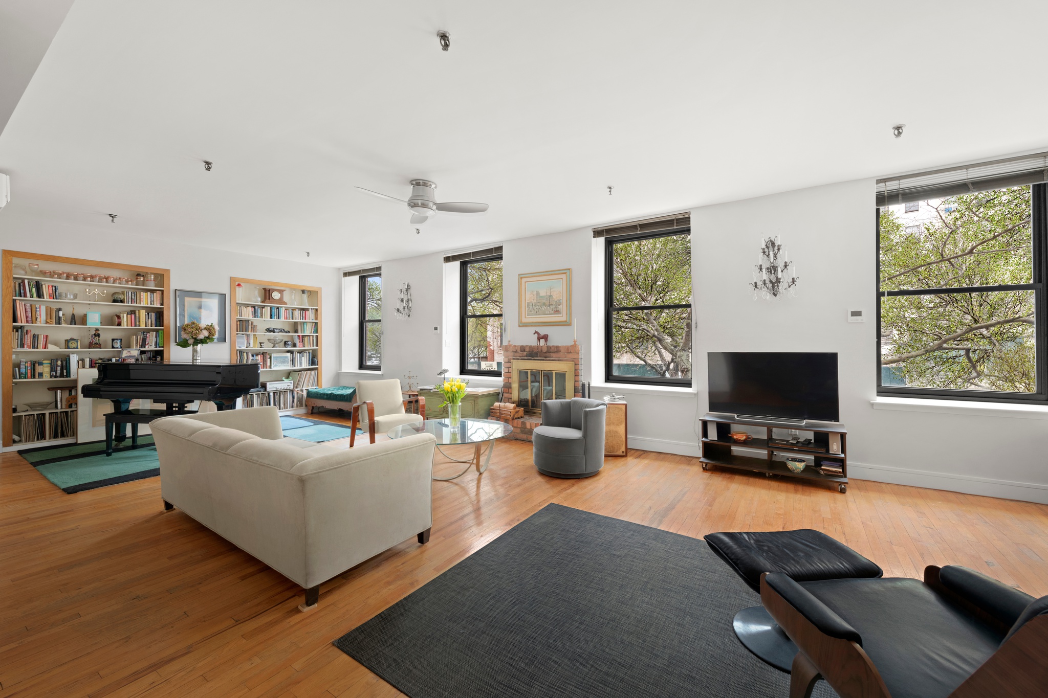 a living room with furniture a flat screen tv and a window