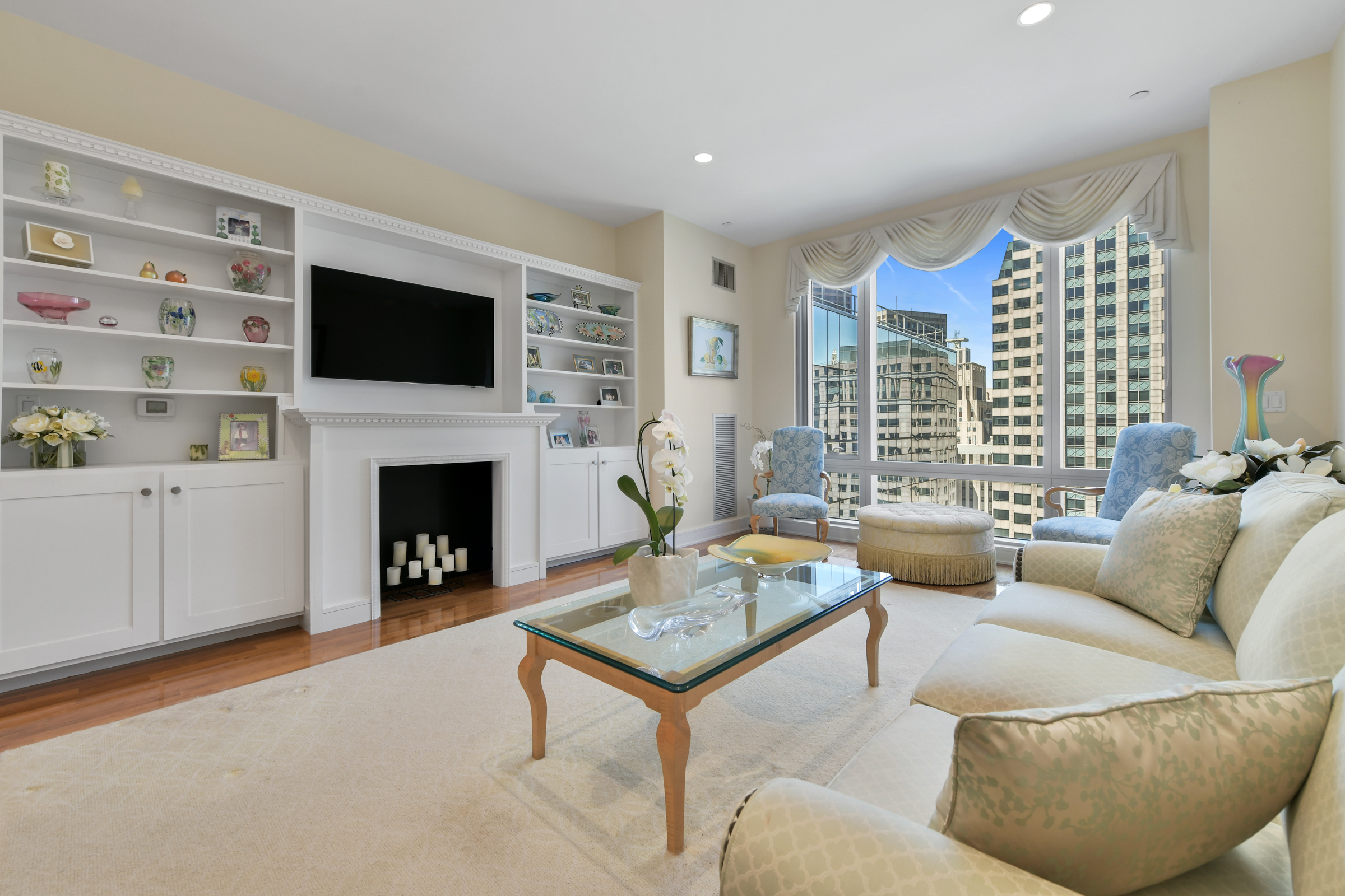 a living room with furniture a flat screen tv and a fireplace