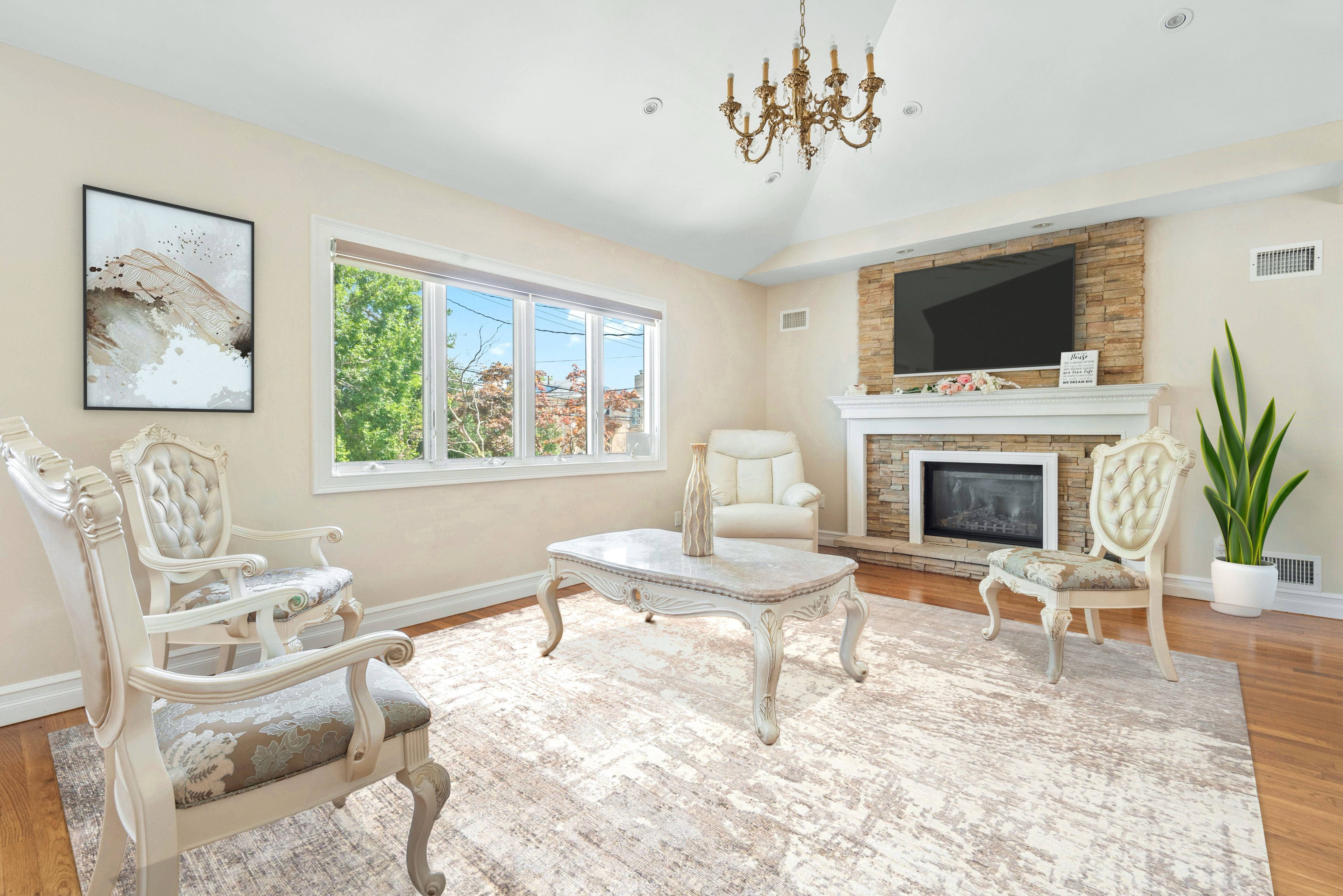 a living room with furniture a flat screen tv and a fireplace