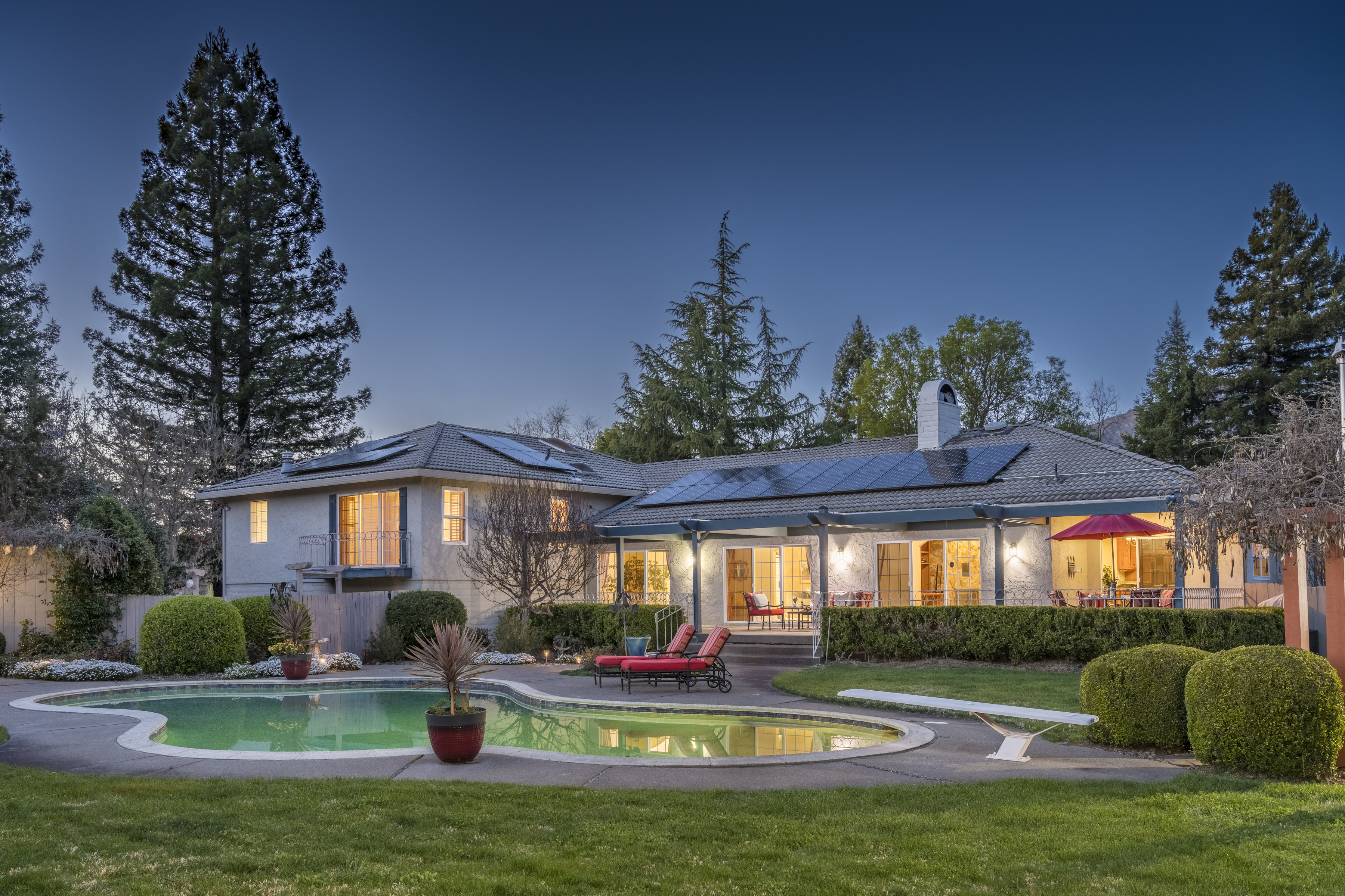 a house view with swimming pool and garden space