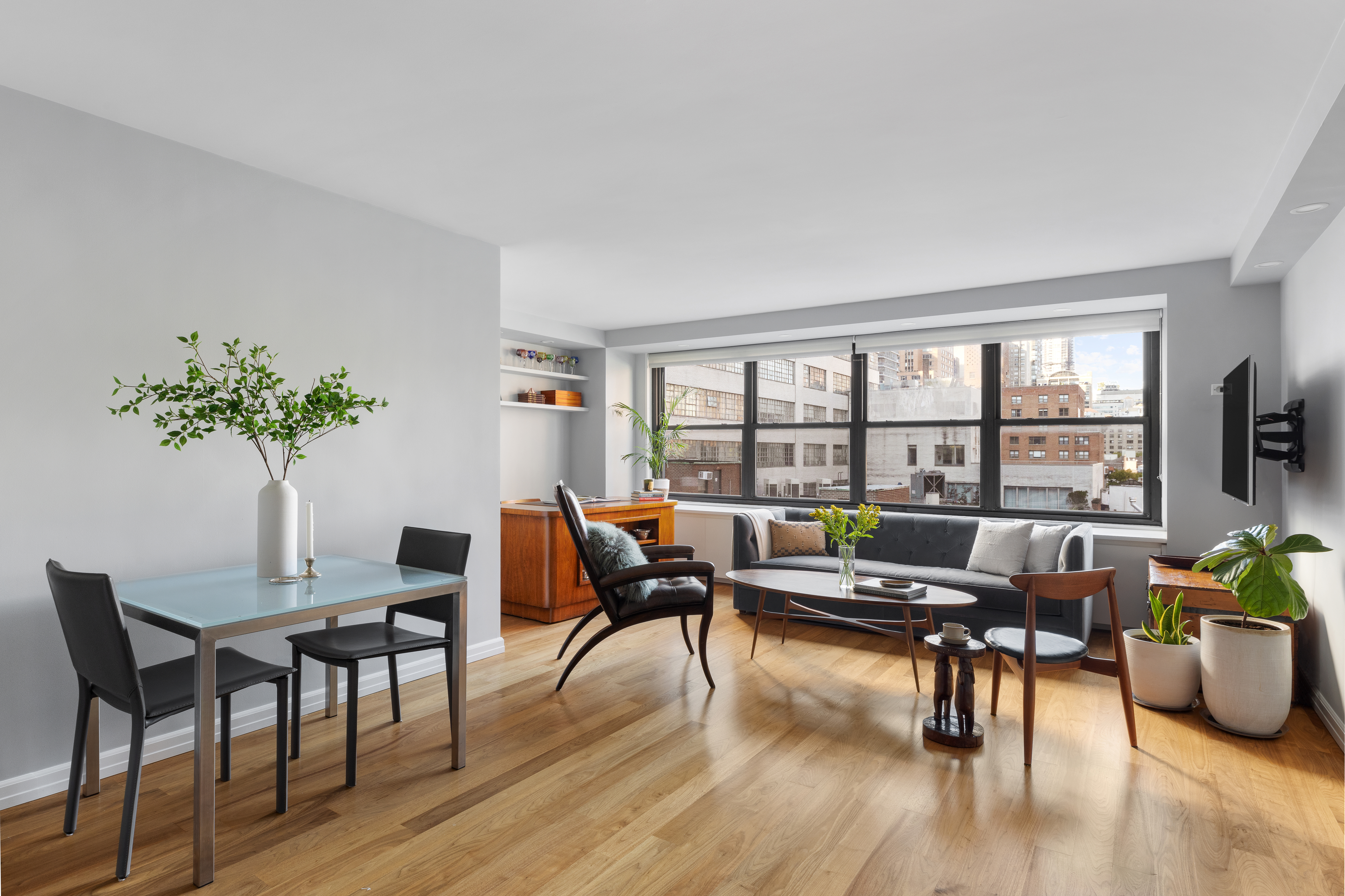 a living room with furniture and a potted plant