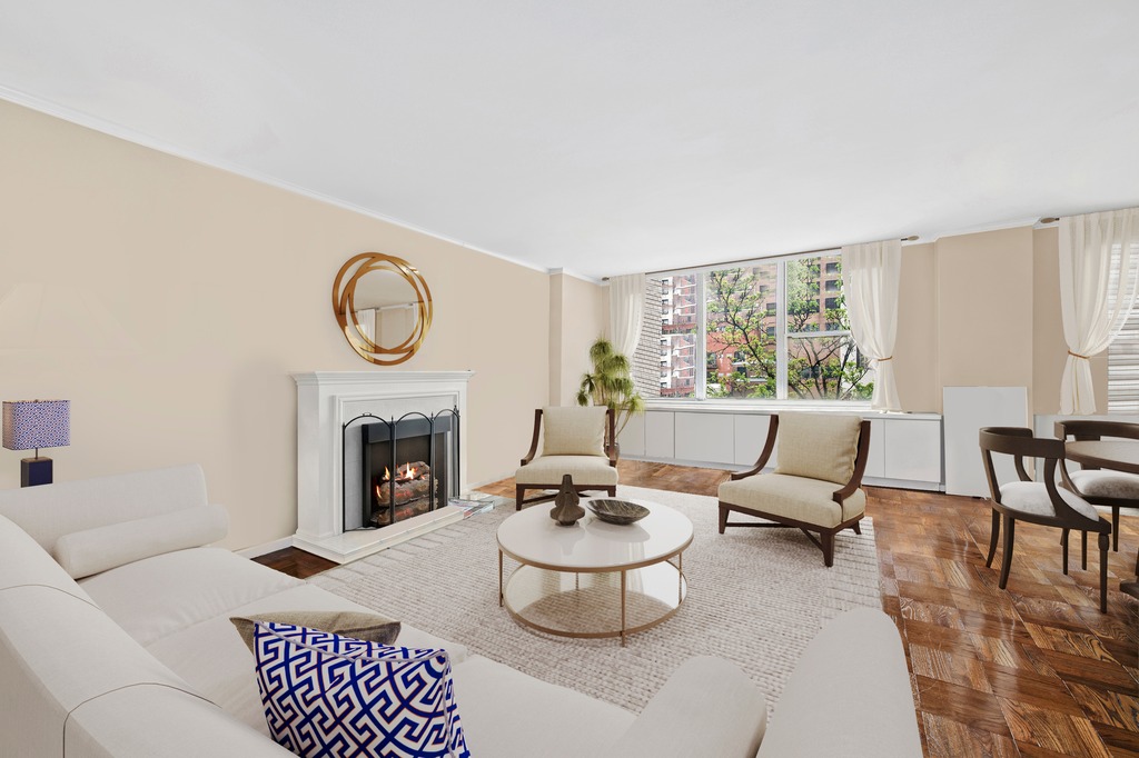 a living room with furniture a fireplace and a table