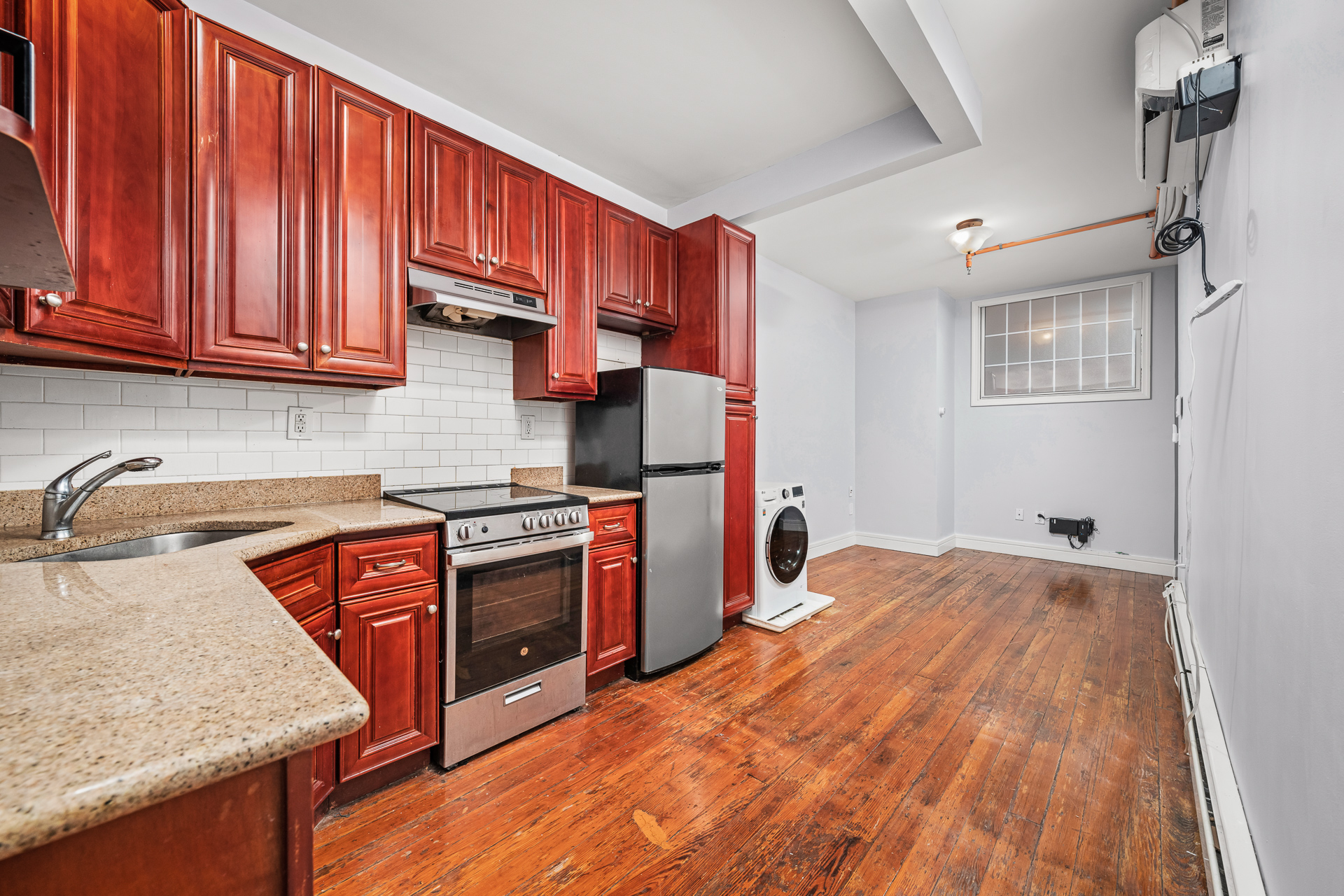 a kitchen with stainless steel appliances granite countertop a sink stove and refrigerator