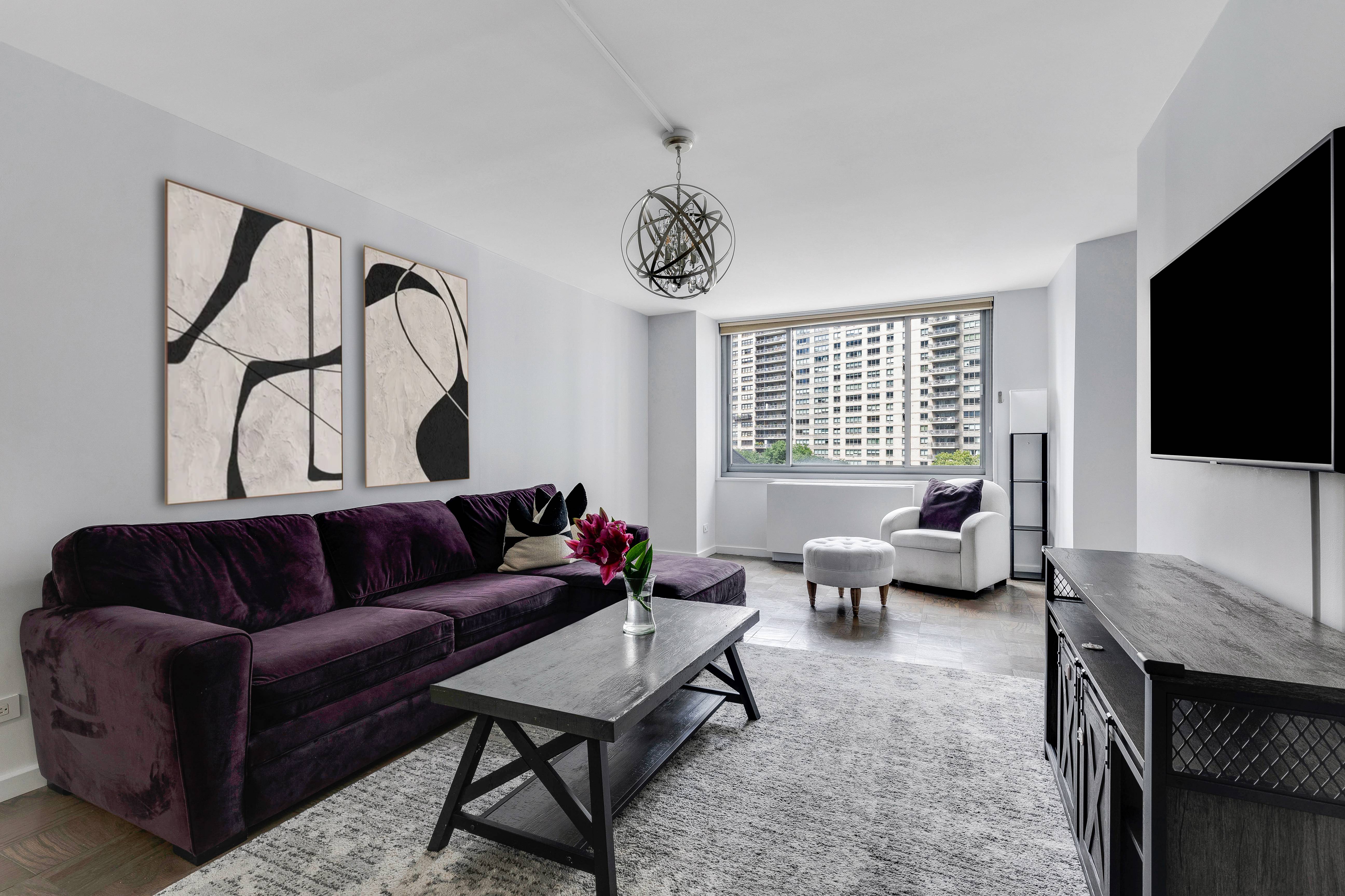 a living room with furniture ceiling fan and a window