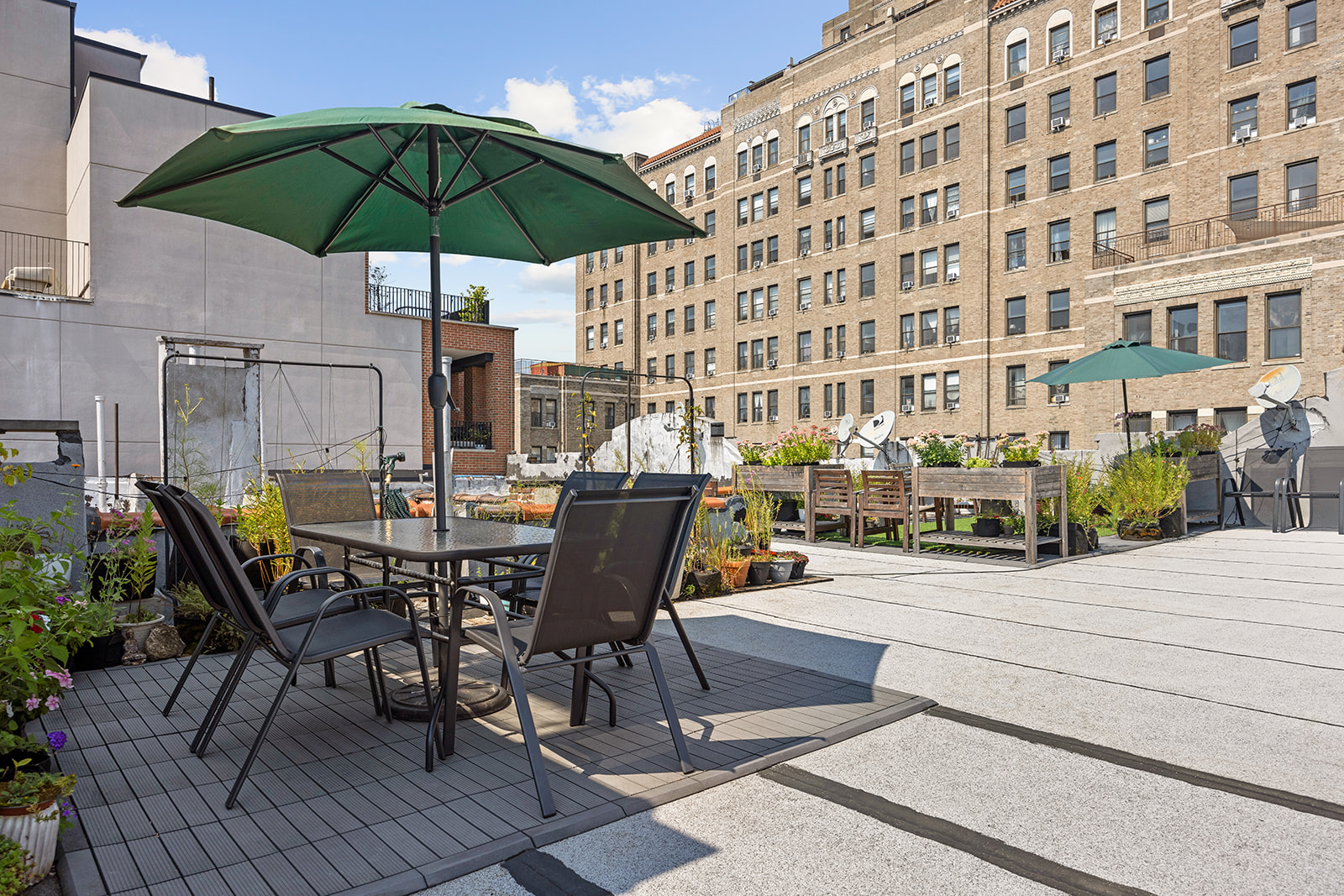 a view of a patio with a table and chairs under an umbrella