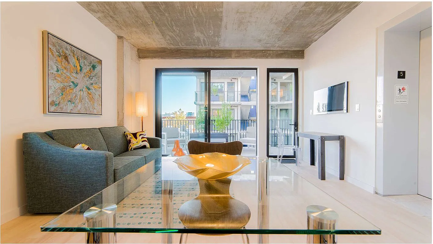 a living room with furniture and a floor to ceiling window