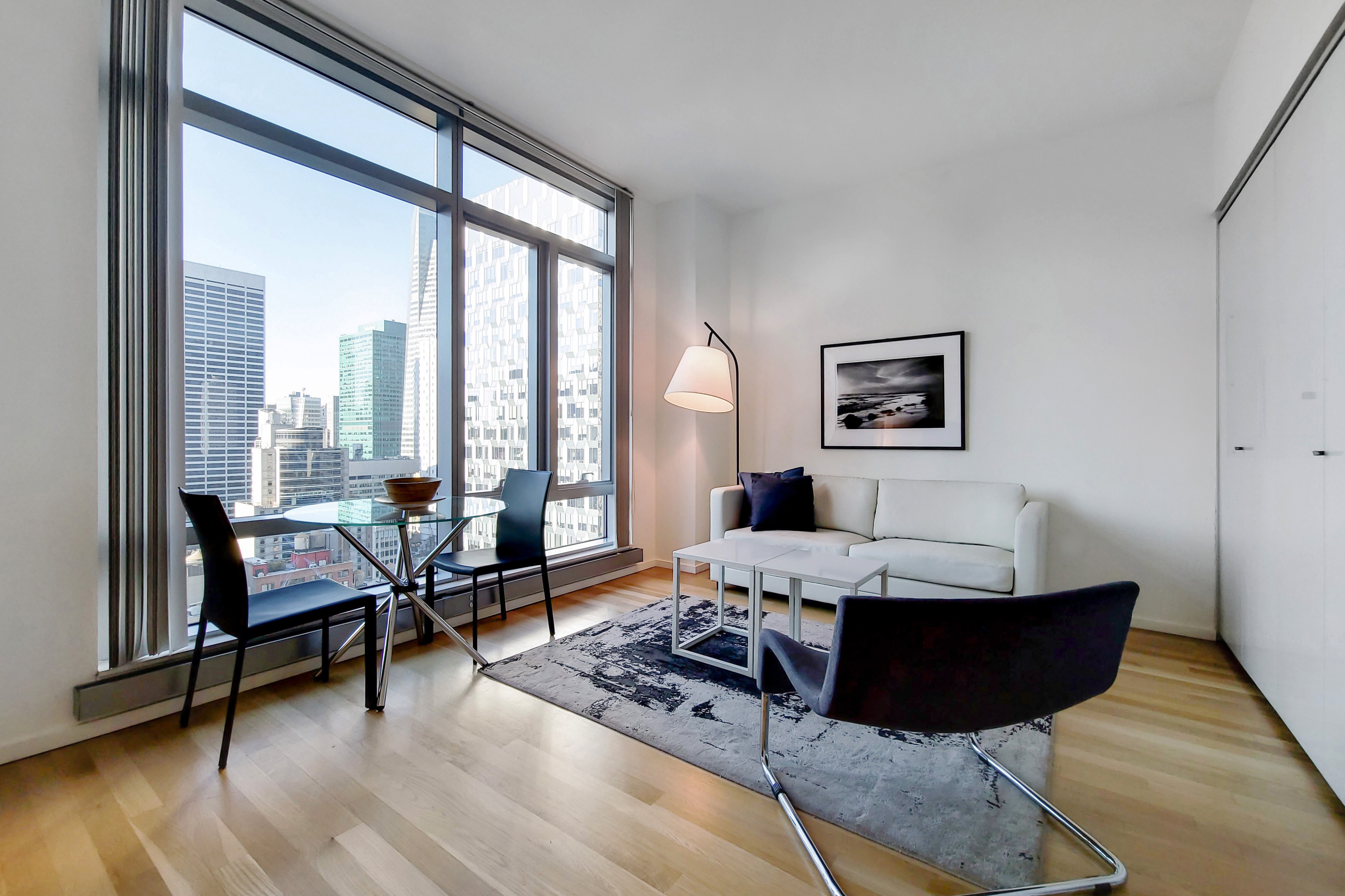 a living room with furniture and floor to ceiling window