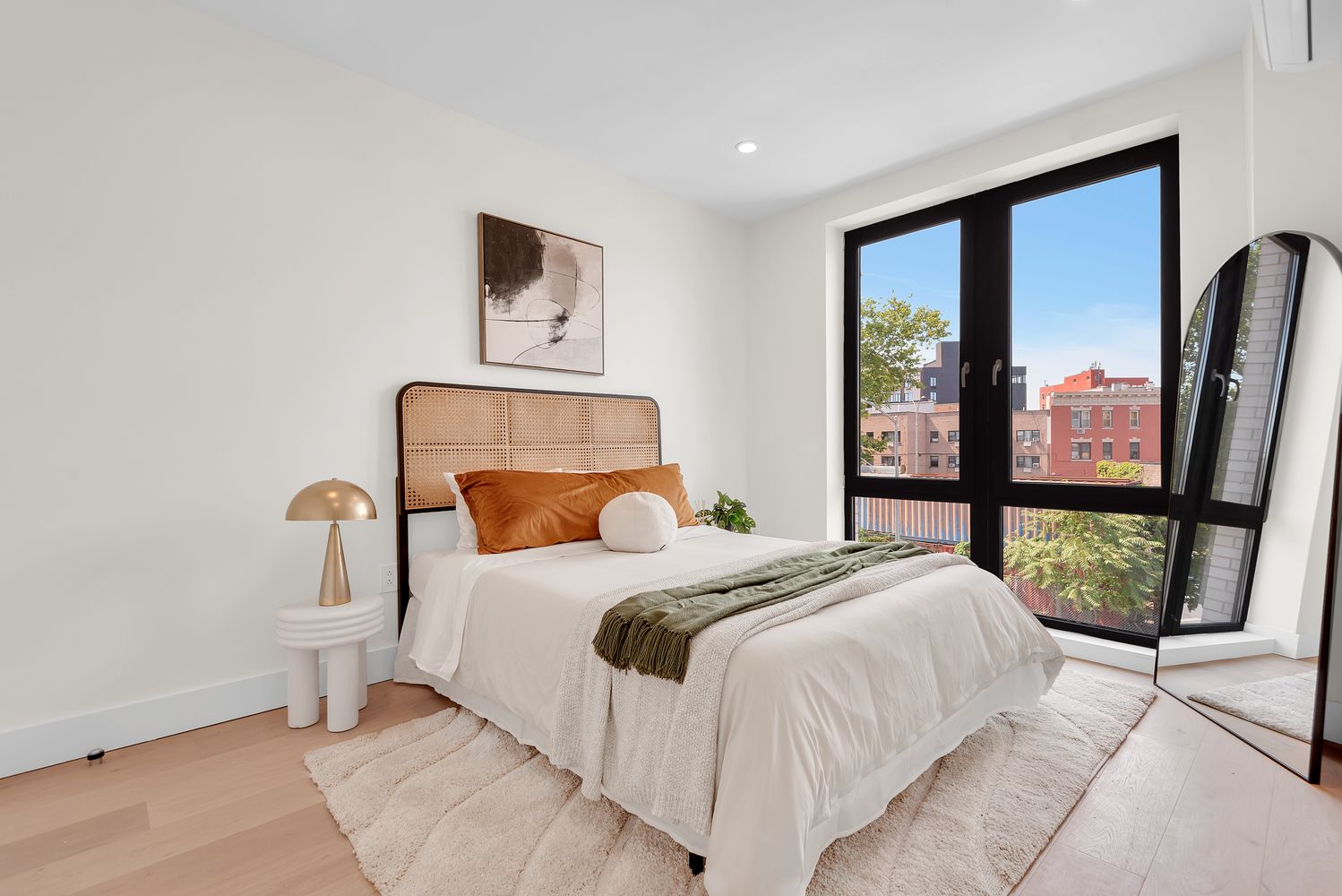 a bedroom with a large bed and a large window