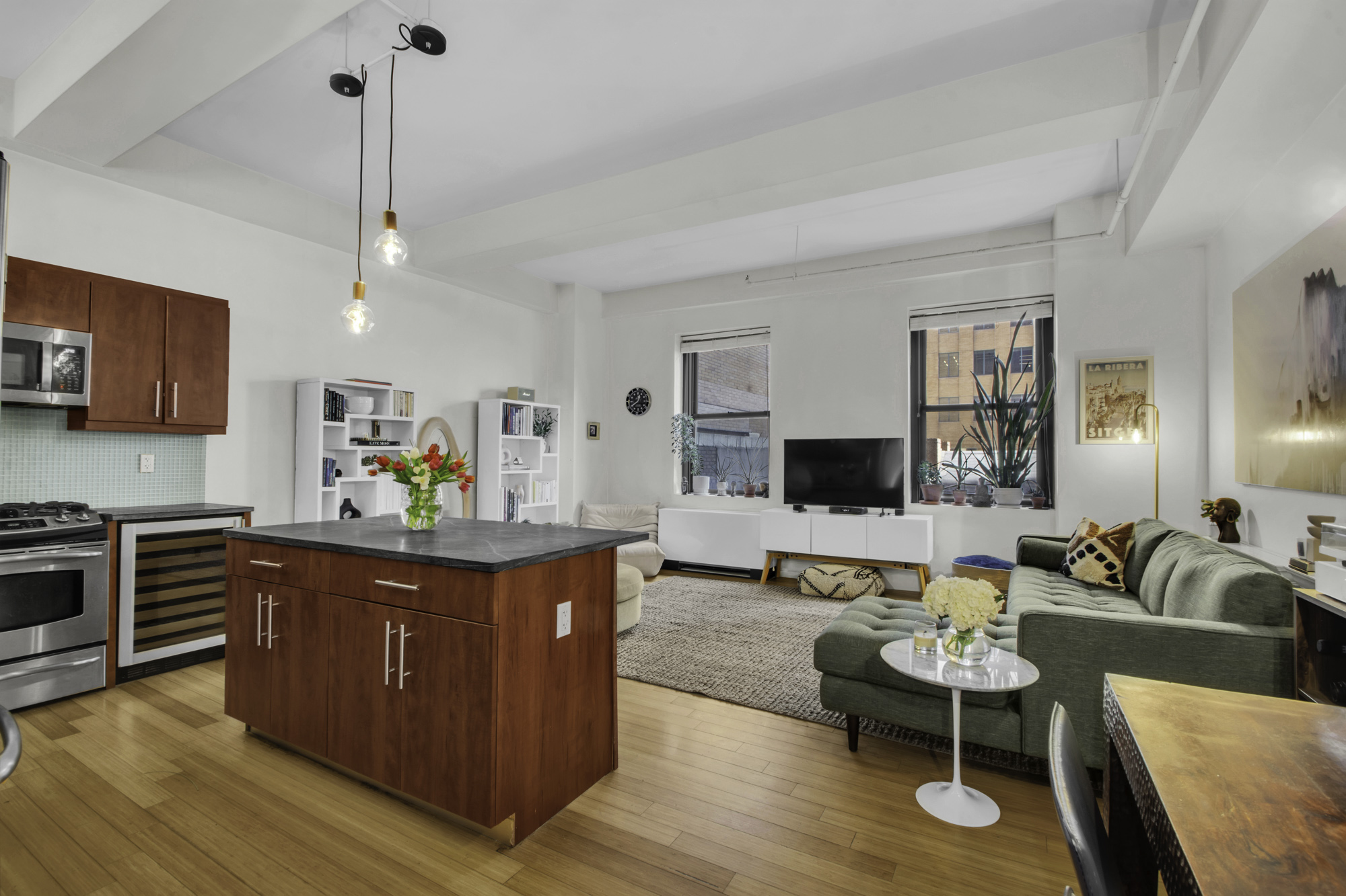 a living room with furniture and wooden floor