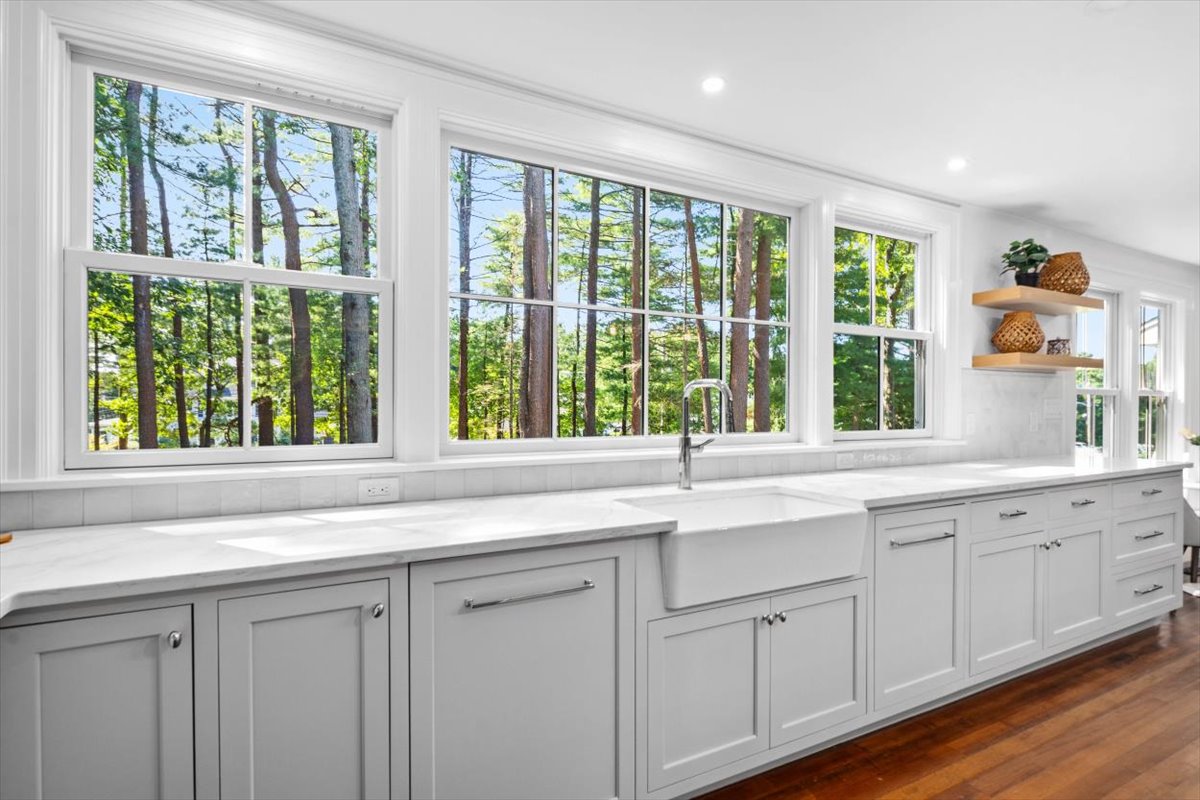 a kitchen with a sink and large window