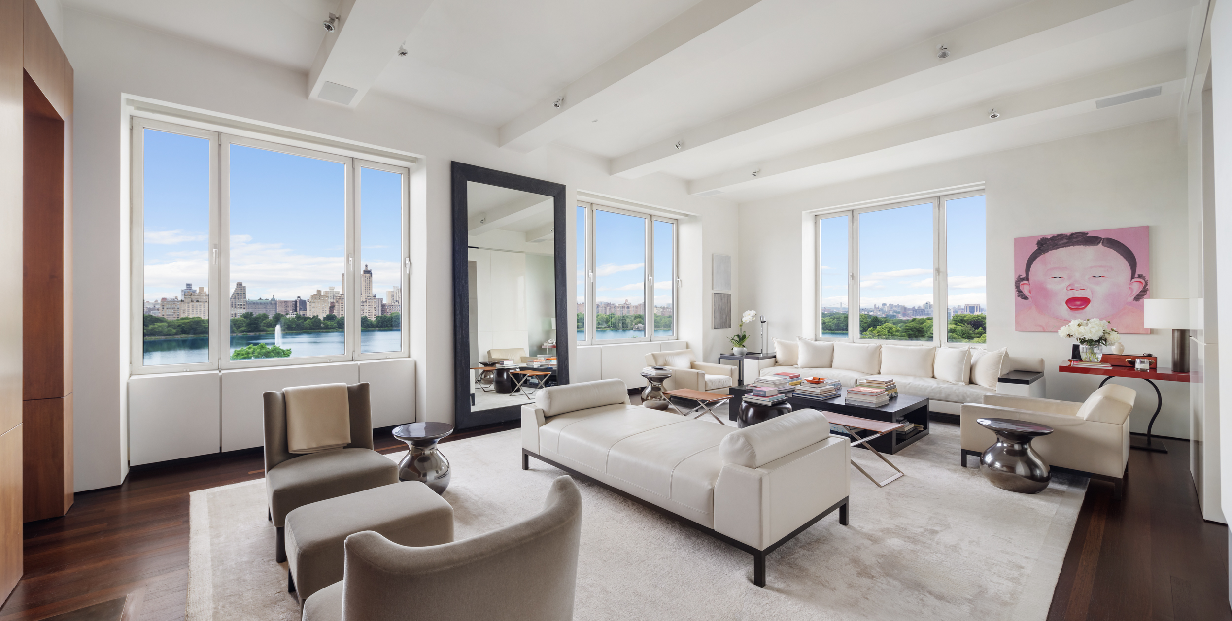 a living room with furniture and large windows