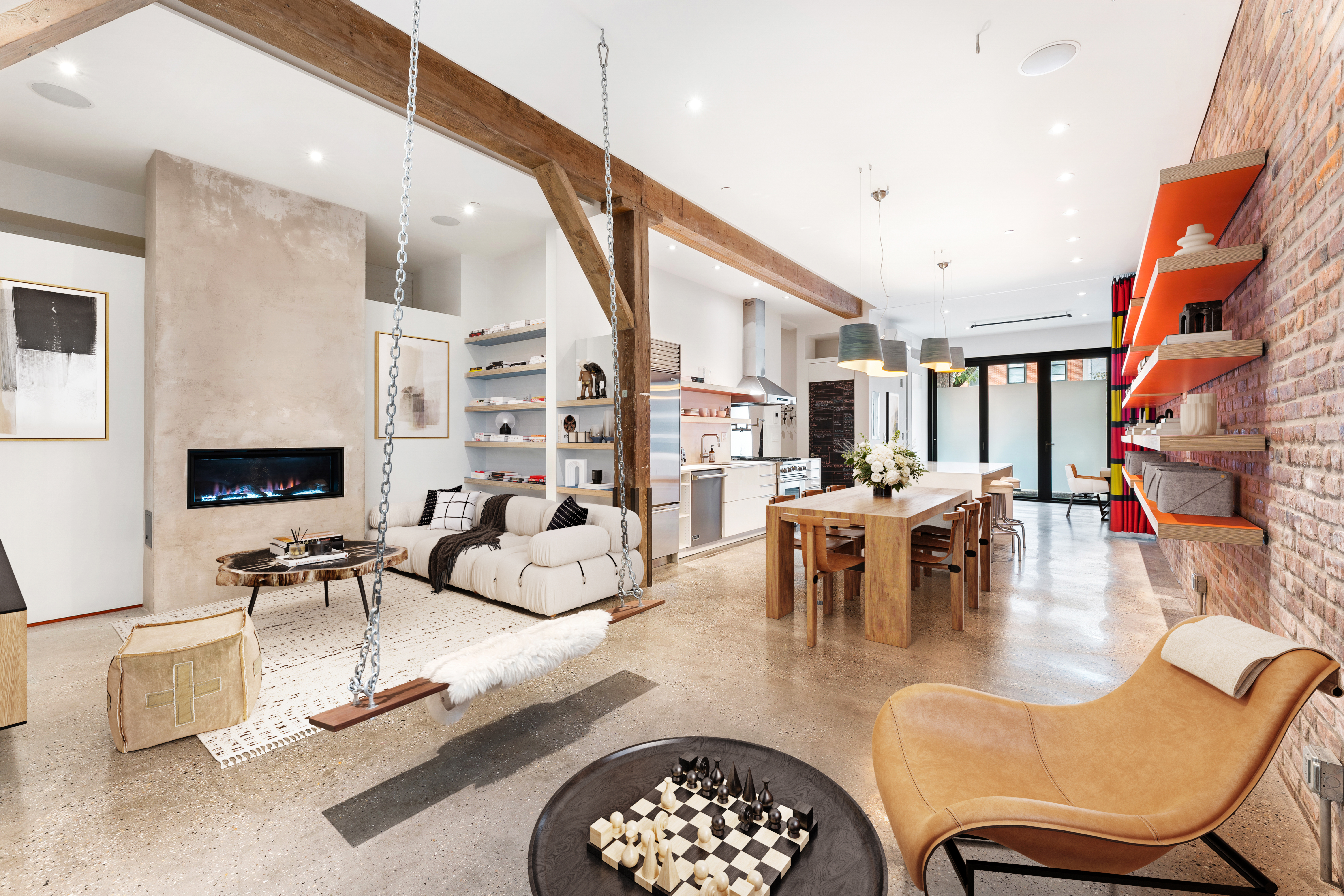 a living room with furniture kitchen view and a large window