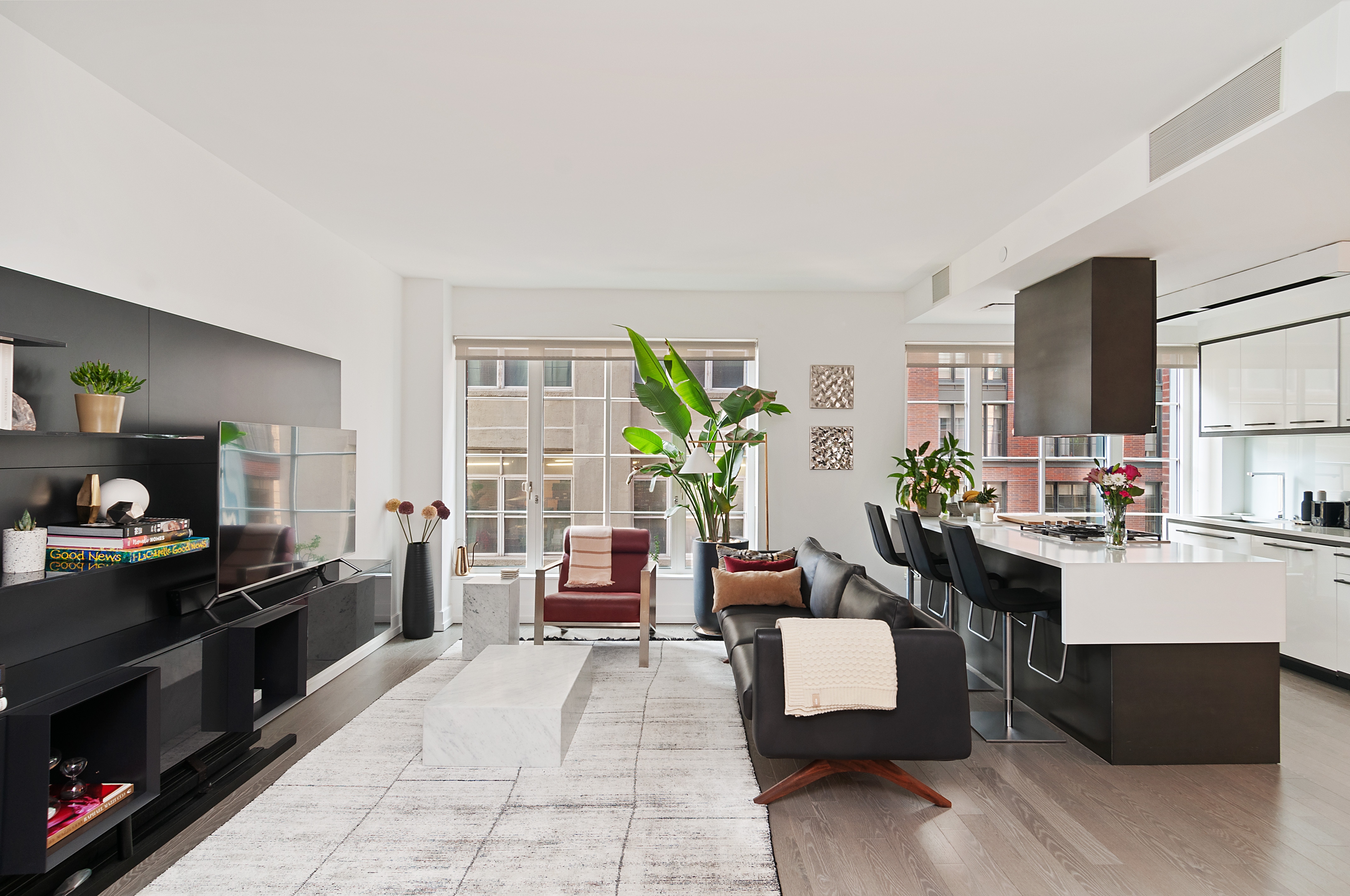 a living room with furniture and a wooden floor